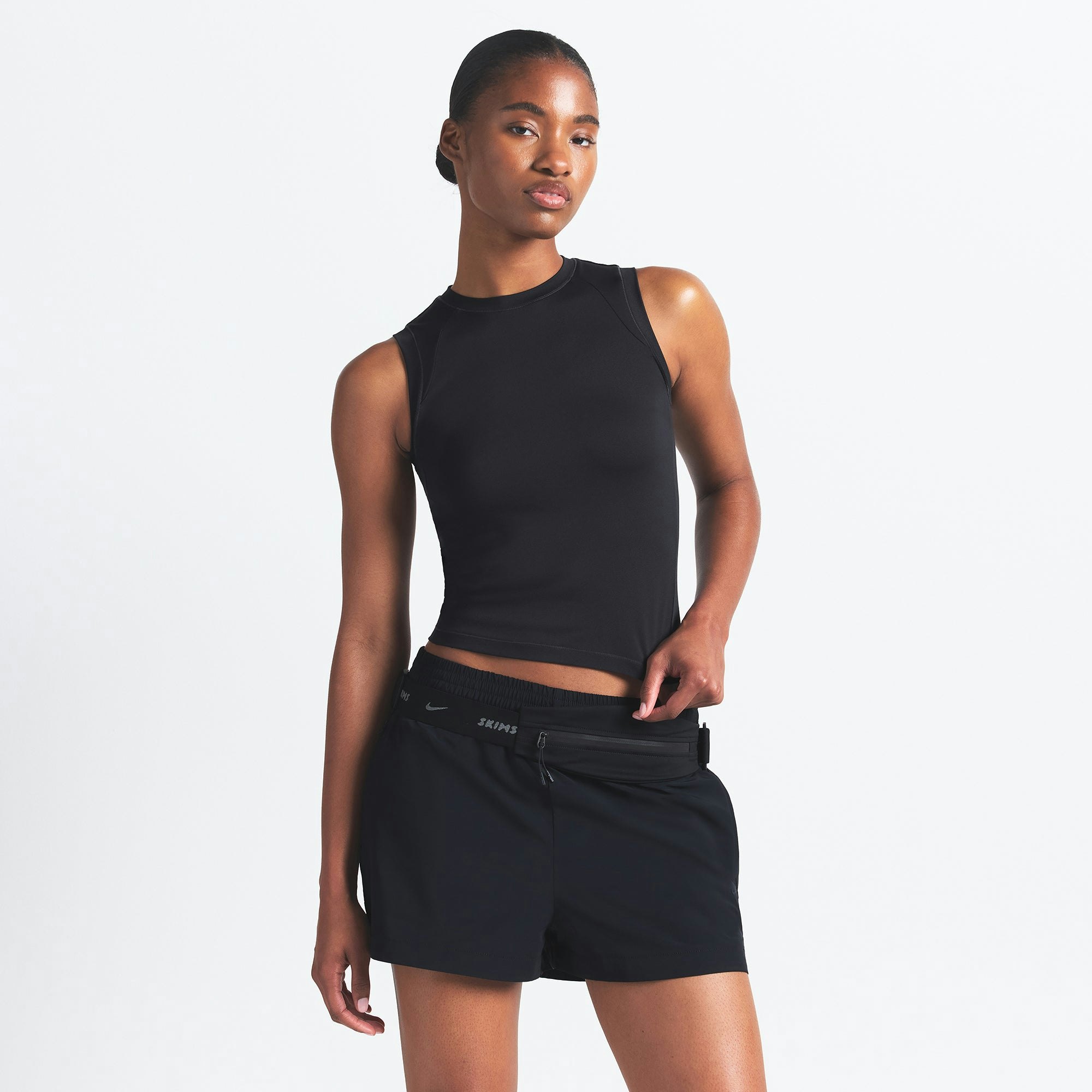 NikeSKIMS AIRY MUSCLE TEE | OBSIDIAN ON A MODEL SIDE VIEW @ | FOCUS: 0.0, 1.0, 0.9