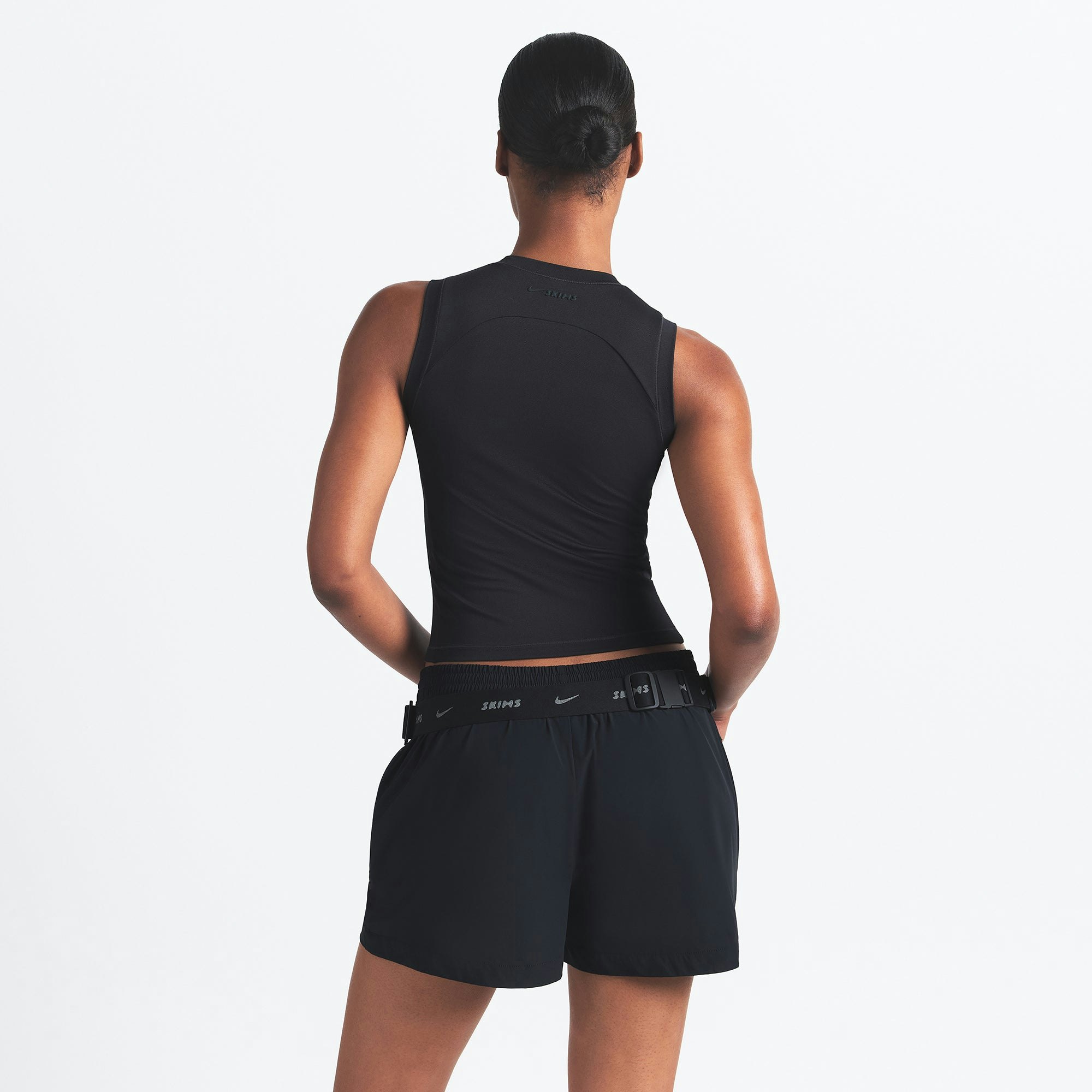 NikeSKIMS AIRY MUSCLE TEE | OBSIDIAN ON A MODEL SIDE VIEW @ | FOCUS: 0.0, 1.0, 0.9