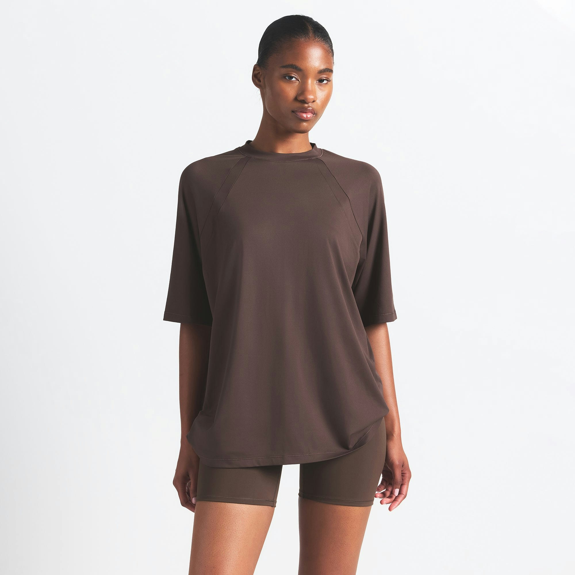 NikeSKIMS AIRY OVERSIZED TEE | DARK SEPIA ON A MODEL SIDE VIEW @ | FOCUS: 0.0, 1.0, 0.9