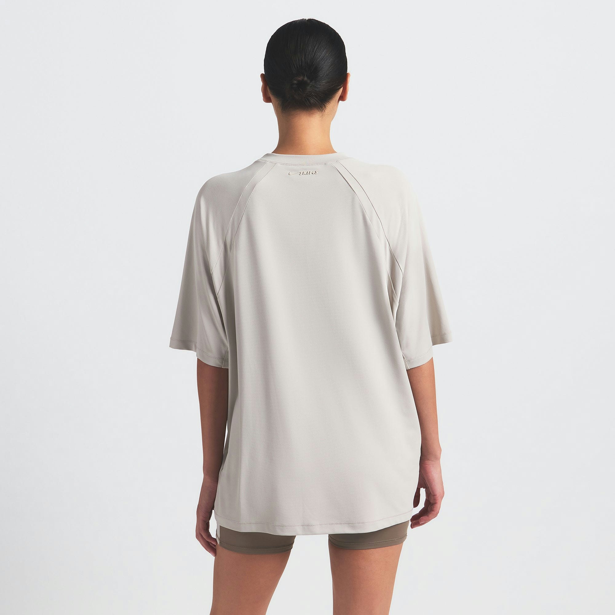 NikeSKIMS AIRY OVERSIZED TEE | STONE ON A MODEL SIDE VIEW @ | FOCUS: 0.0, 1.0, 0.9