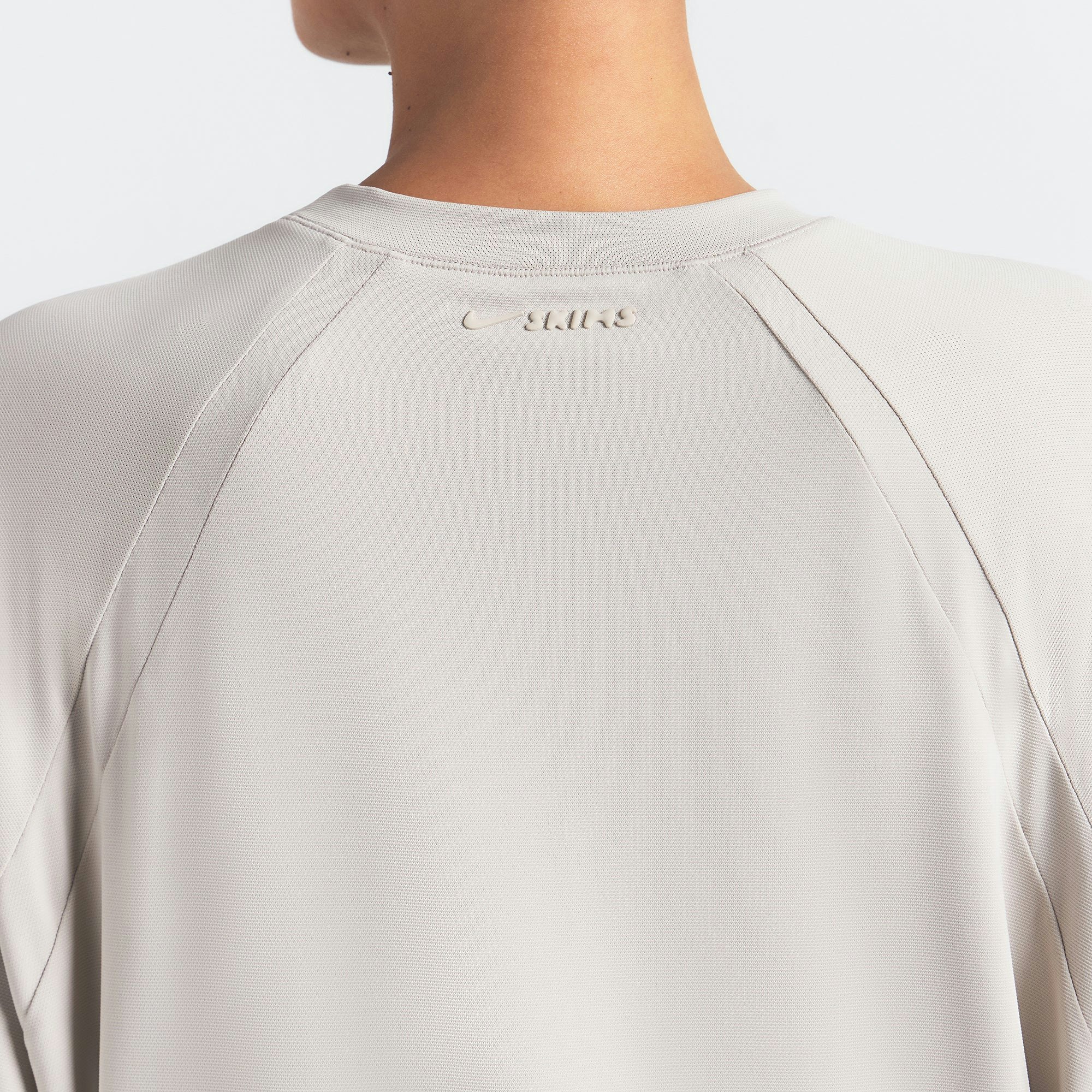 NikeSKIMS AIRY OVERSIZED TEE | STONE ON A MODEL SIDE VIEW @ | FOCUS: 0.0, 1.0, 0.9
