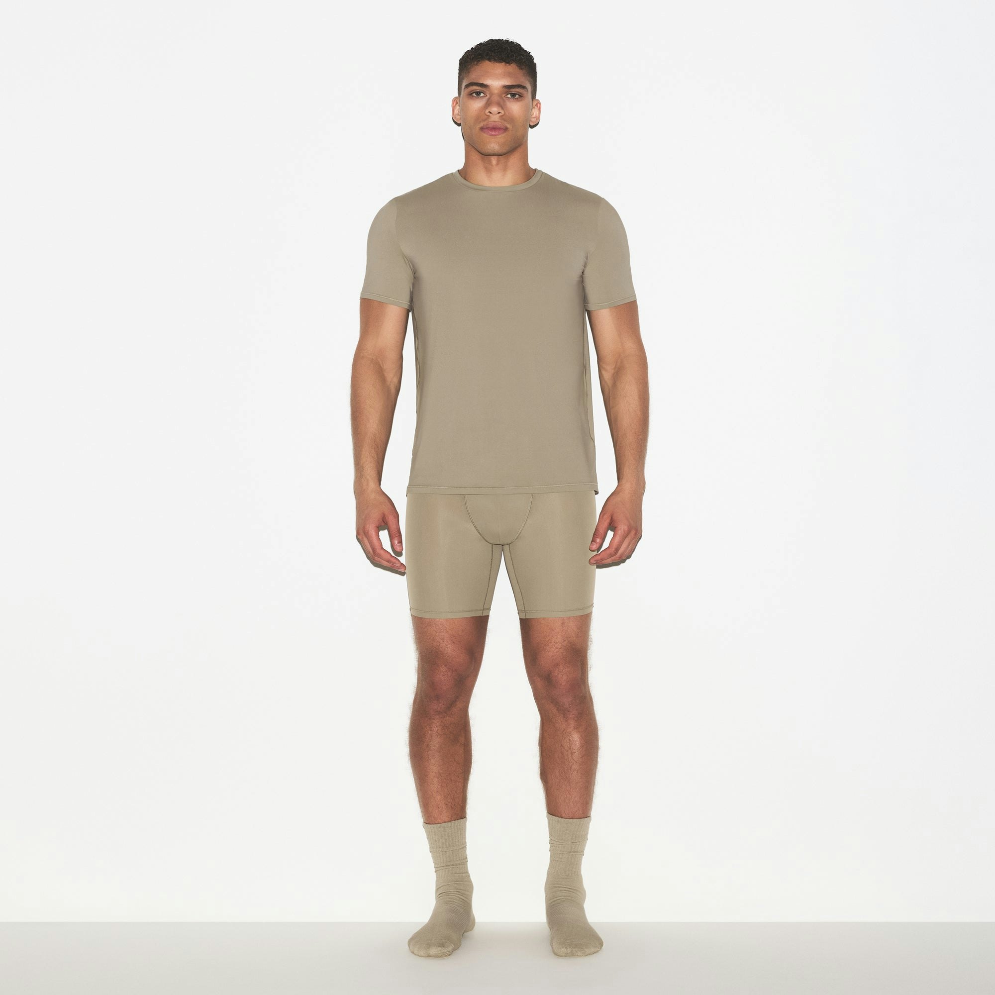 SKIMS SPORT MENS T-SHIRT | DUNE ON A MODEL FRONT VIEW @ | FOCUS: 0.0, 1.0, 0.9