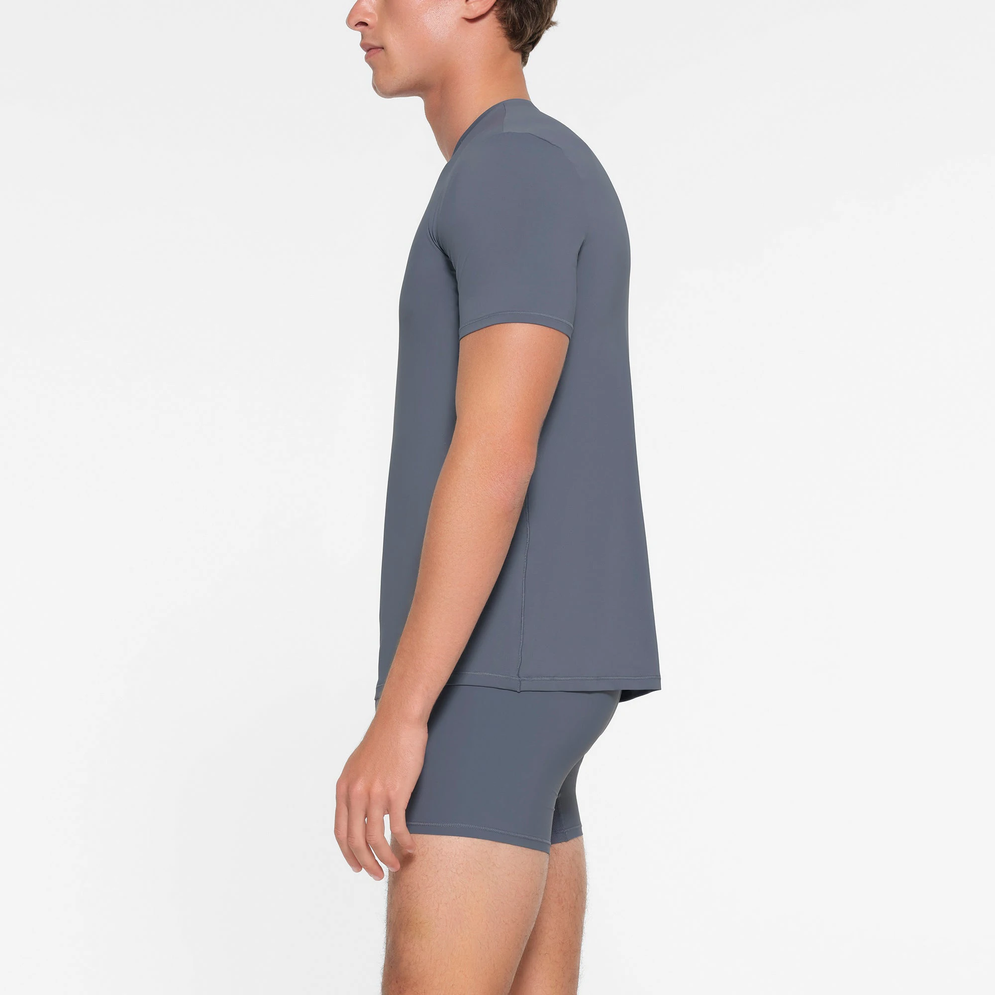 SKIMS SPORT MENS T-SHIRT | STEEL BLUE ON A MODEL SIDE VIEW