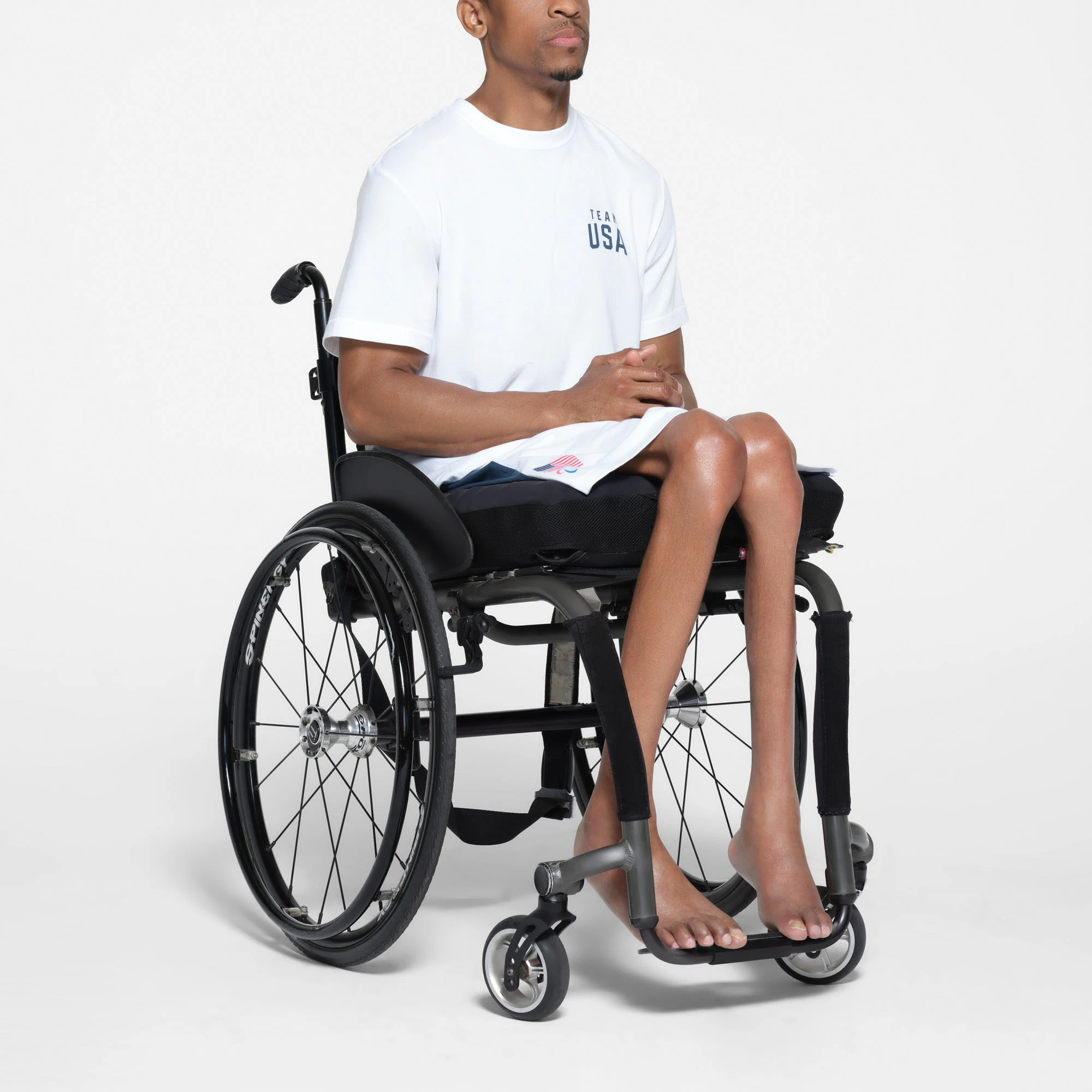 SKIMS FOR TEAM USA SKIMS COTTON MENS PARALYMPIC T-SHIRT | WHITE ON A MODEL SIDE VIEW