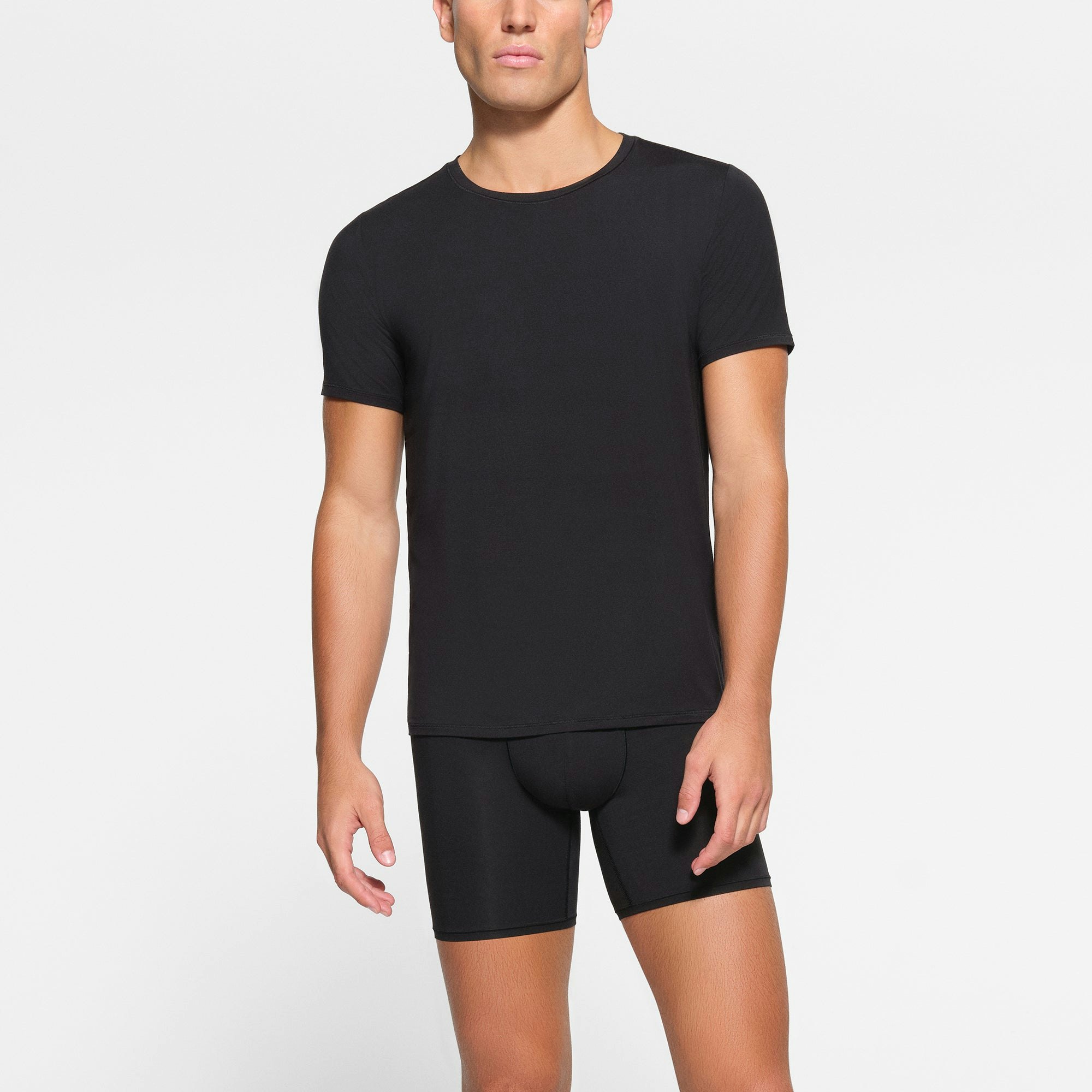 SKIMS STRETCH MENS T-SHIRT 3-PACK WORN BY A MODEL IN FRONT VIEW