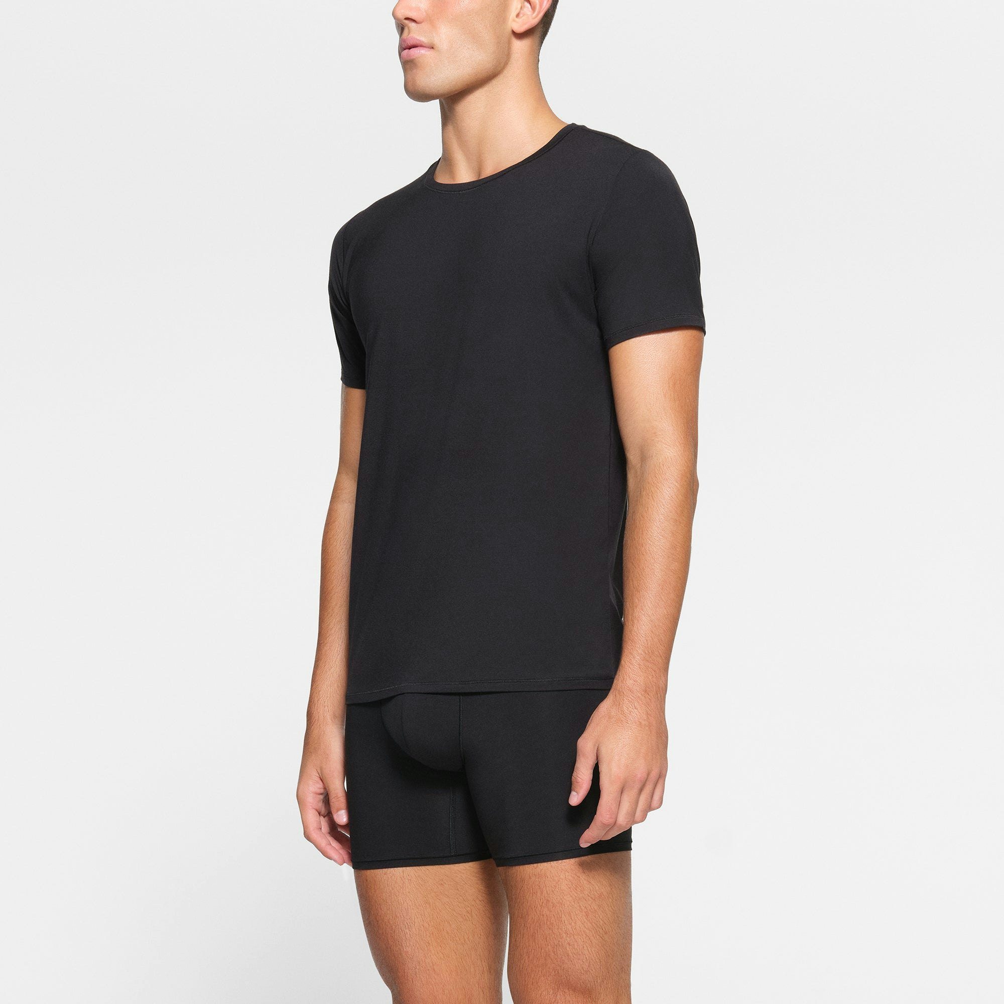 SKIMS STRETCH MENS T-SHIRT 3-PACK WORN BY A MODEL IN SIDE VIEW