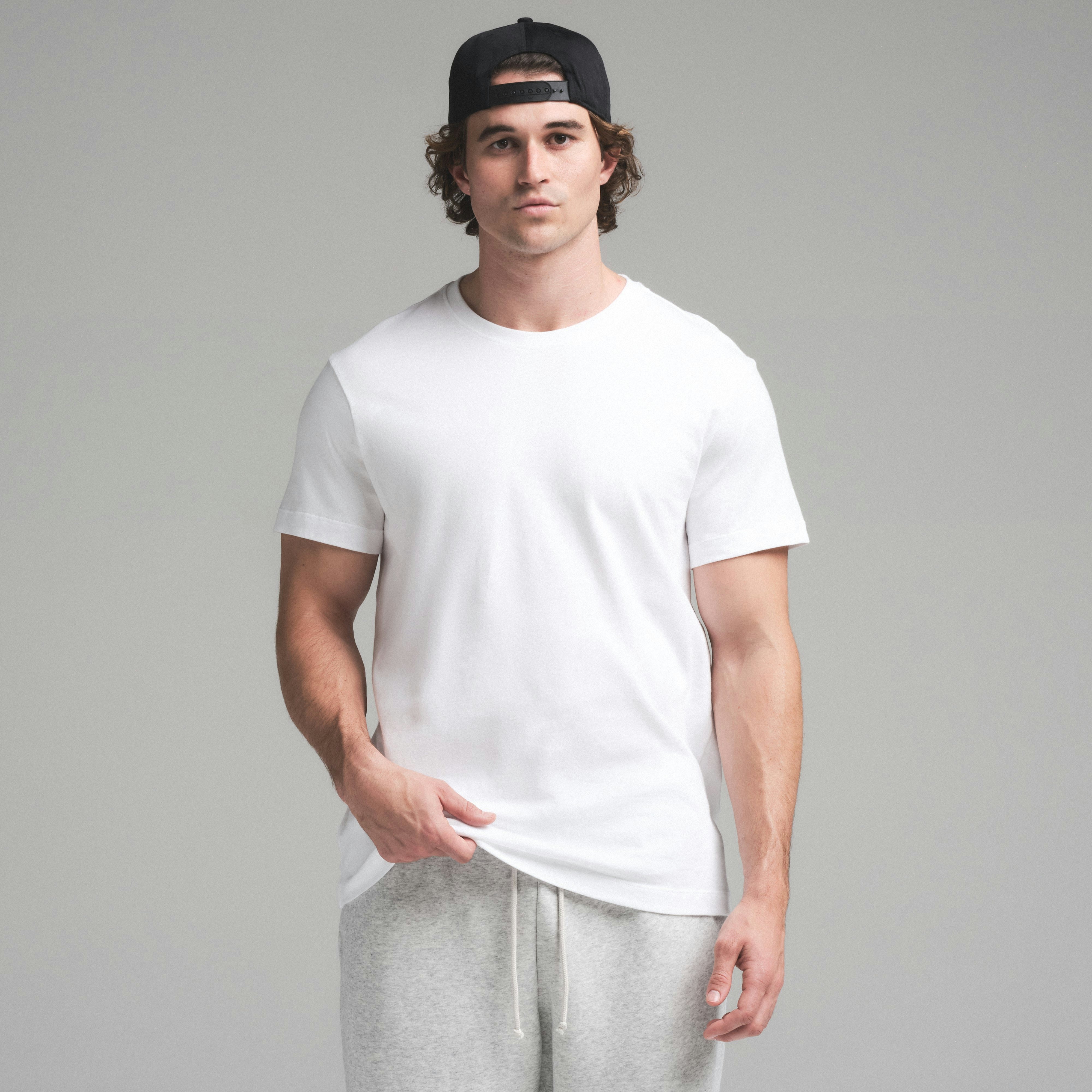 SKIMS COTTON MENS CLASSIC T-SHIRT | CHALK ON A MODEL SIDE VIEW | FOCUS: 0.0, 1.0, 0.9