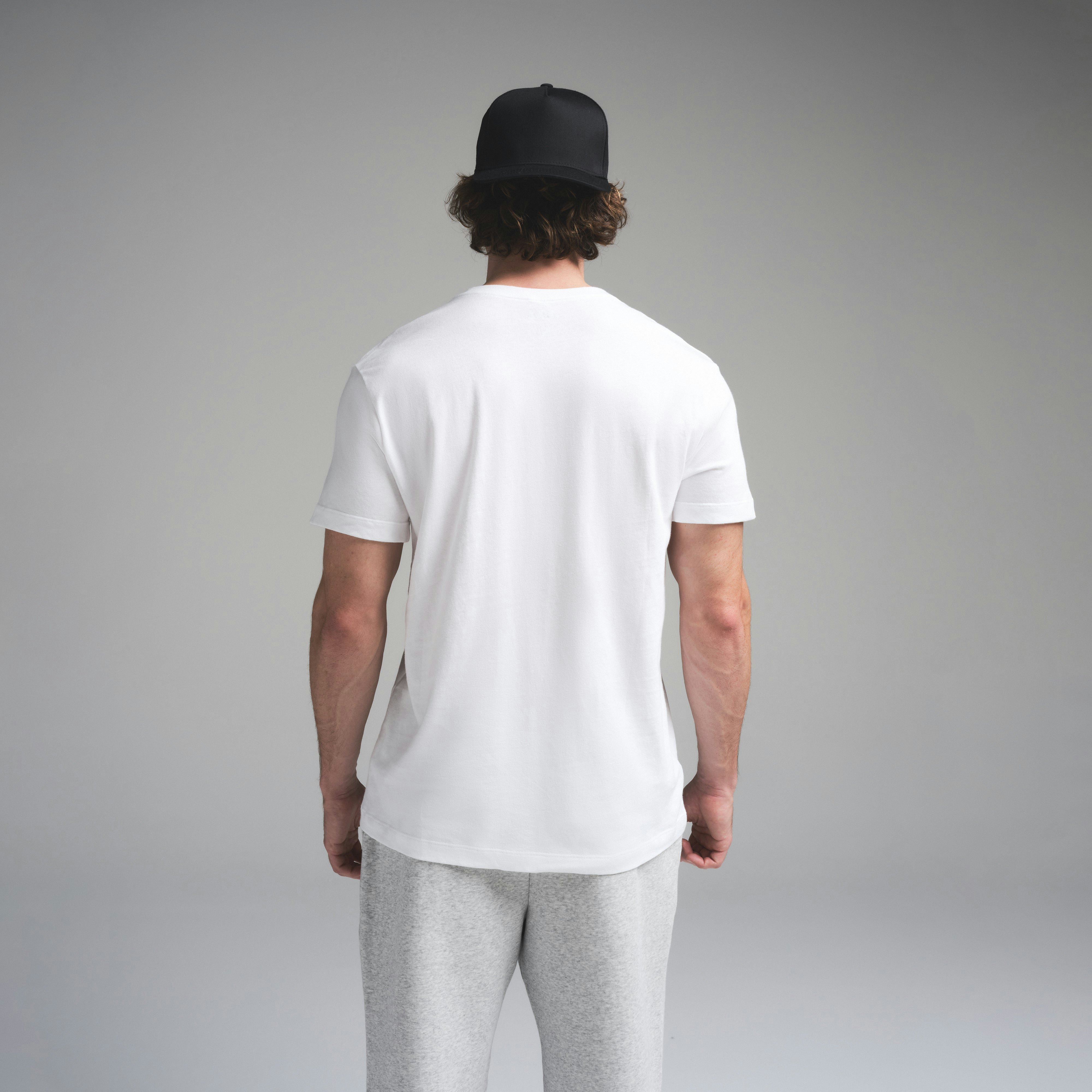 SKIMS COTTON MENS CLASSIC T-SHIRT | CHALK ON A MODEL SIDE VIEW | FOCUS: 0.0, 1.0, 0.9