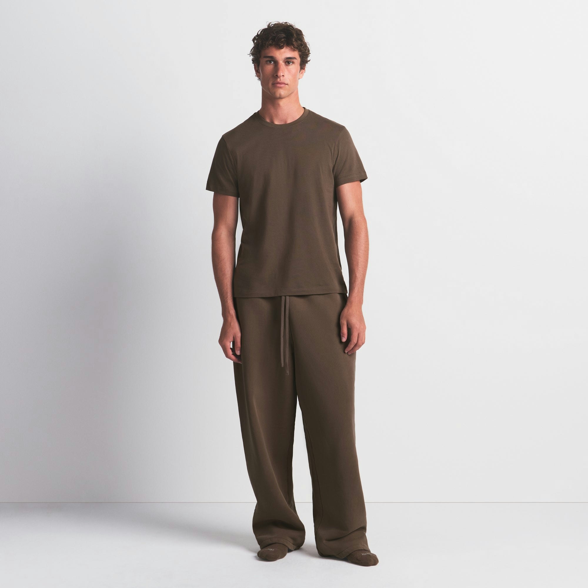 SKIMS COTTON MENS CLASSIC T-SHIRT | DRIFTWOOD ON A MODEL FRONT VIEW @ | FOCUS: 0.0, 1.0, 0.9