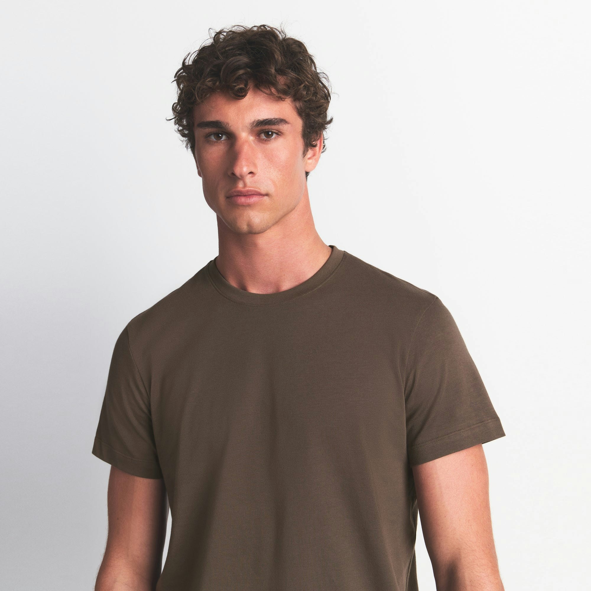 SKIMS COTTON MENS CLASSIC T-SHIRT | DRIFTWOOD ON A MODEL FRONT VIEW @ | FOCUS: 0.0, 1.0, 0.9