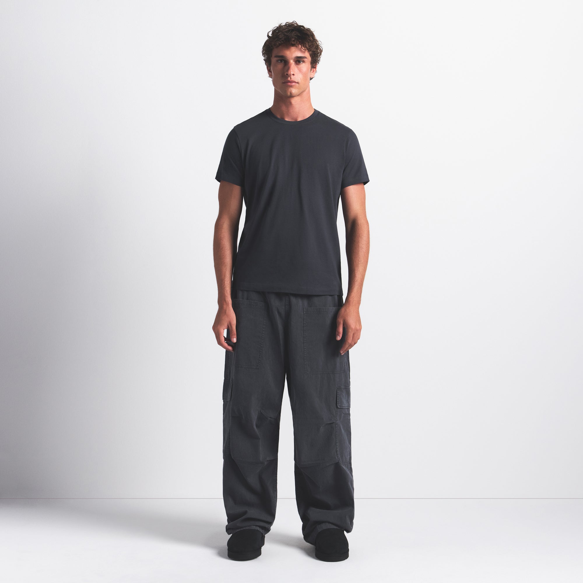 SKIMS COTTON MENS CLASSIC T-SHIRT | GRAPHITE ON A MODEL FRONT VIEW @ | FOCUS: 0.0, 1.0, 0.9