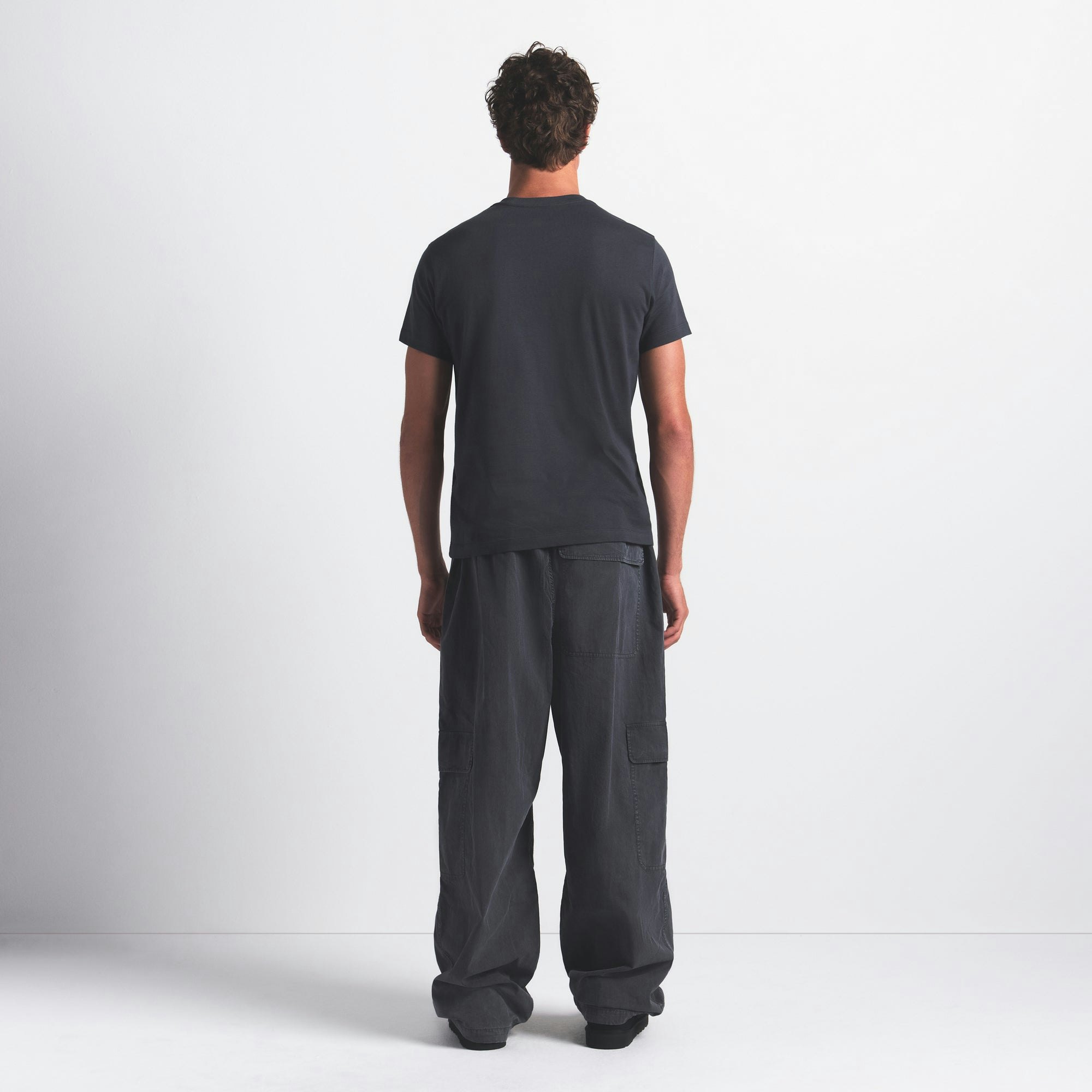 SKIMS COTTON MENS CLASSIC T-SHIRT | GRAPHITE ON A MODEL FRONT VIEW @ | FOCUS: 0.0, 1.0, 0.9