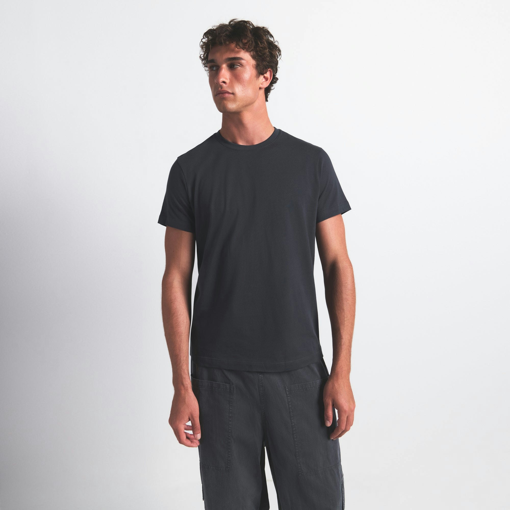 SKIMS COTTON MENS CLASSIC T-SHIRT | GRAPHITE ON A MODEL FRONT VIEW @ | FOCUS: 0.0, 1.0, 0.9