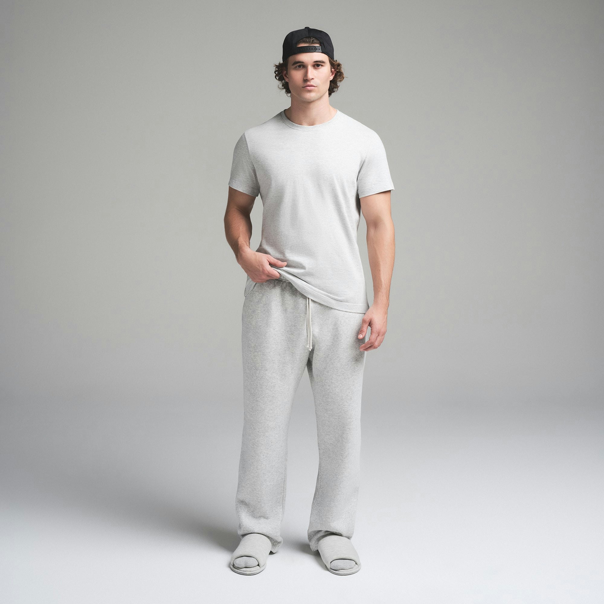 SKIMS COTTON MENS CLASSIC T-SHIRT | LIGHT HEATHER GREY ON A MODEL FRONT VIEW | FOCUS: 0.0, 1.0, 0.9