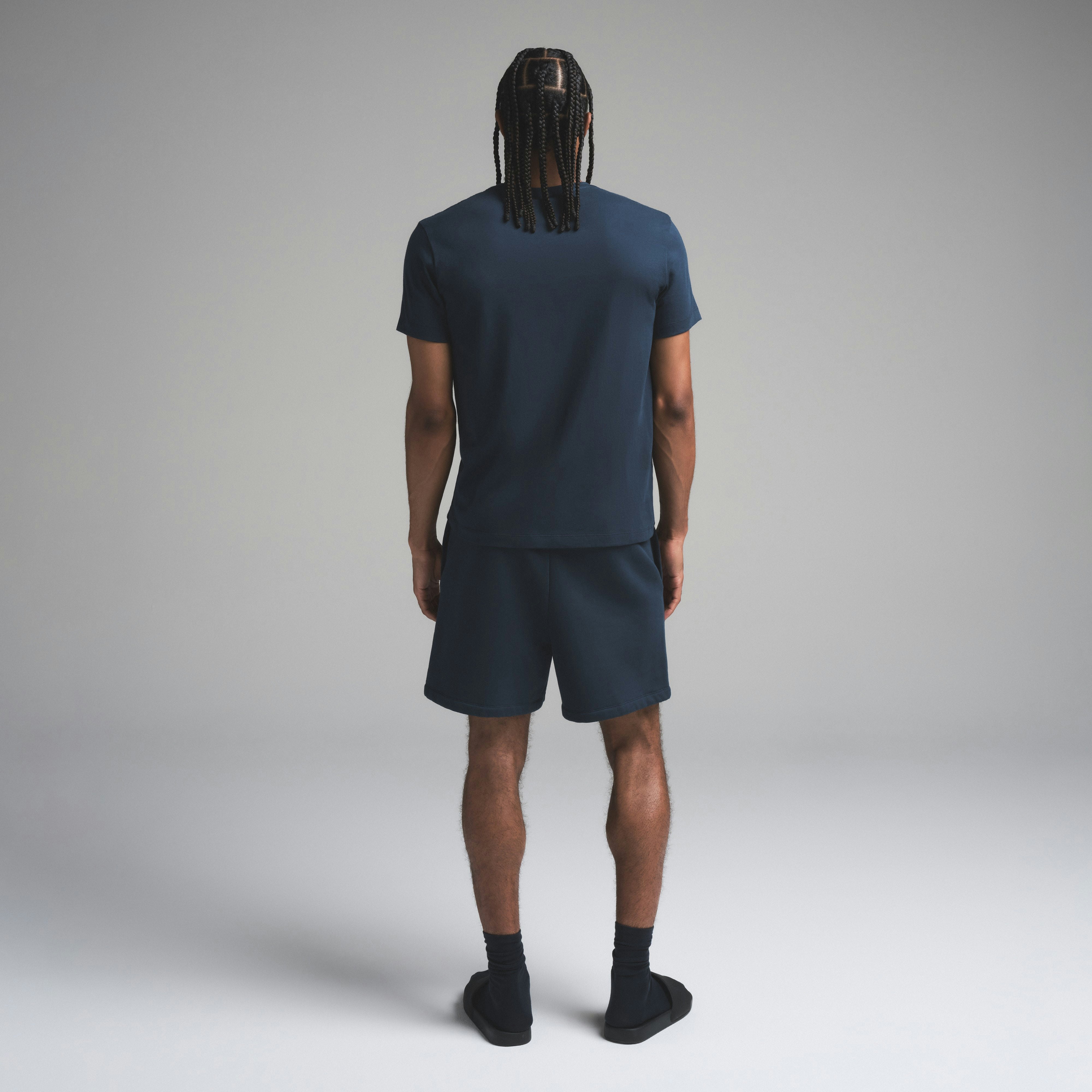 SKIMS COTTON MENS CLASSIC T-SHIRT | NAVY ON A MODEL SIDE VIEW | FOCUS: 0.0, 1.0, 0.9