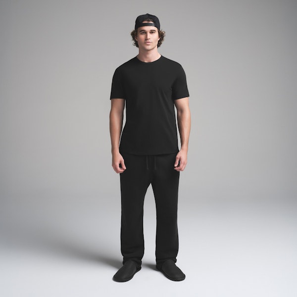 SKIMS COTTON MENS CLASSIC T-SHIRT | ONYX ON A MODEL FRONT VIEW | FOCUS: 0.0, 1.0, 0.9