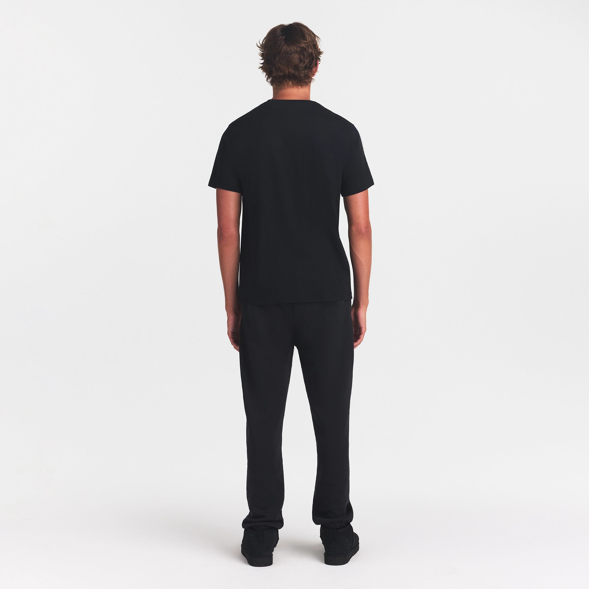 SKIMS COTTON MENS CLASSIC T-SHIRT | ONYX ON A MODEL BACK VIEW @ | FOCUS: 0.0, 1.0, 0.9