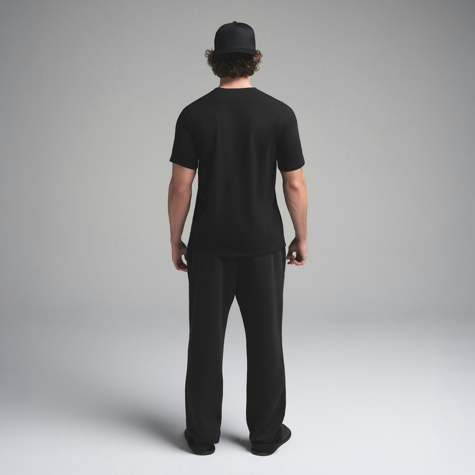 SKIMS COTTON MENS CLASSIC T-SHIRT | ONYX ON A MODEL SIDE VIEW | FOCUS: 0.0, 1.0, 0.9