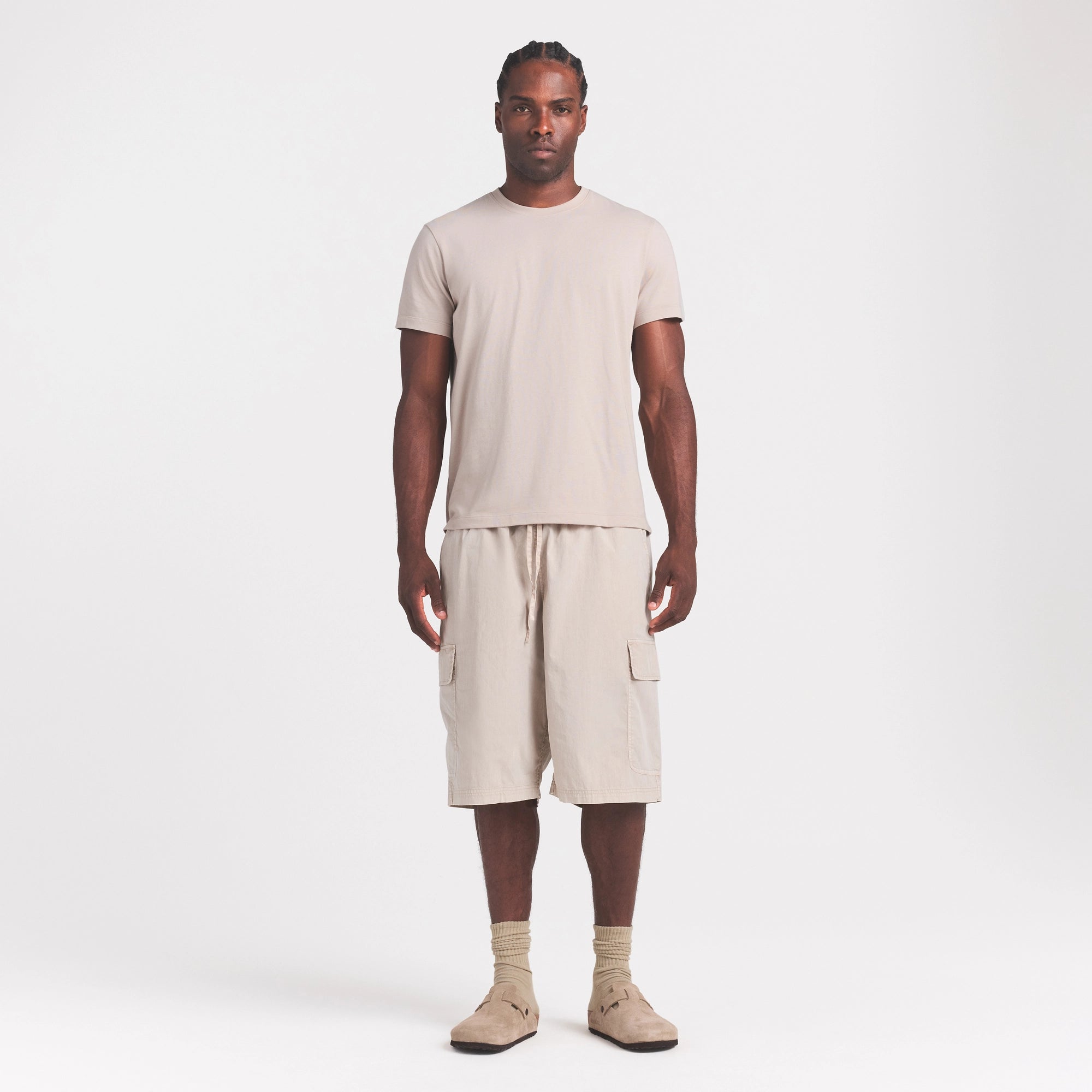 SKIMS COTTON MENS CLASSIC T-SHIRT | STONE ON A MODEL FRONT VIEW @ | FOCUS: 0.0, 1.0, 0.9