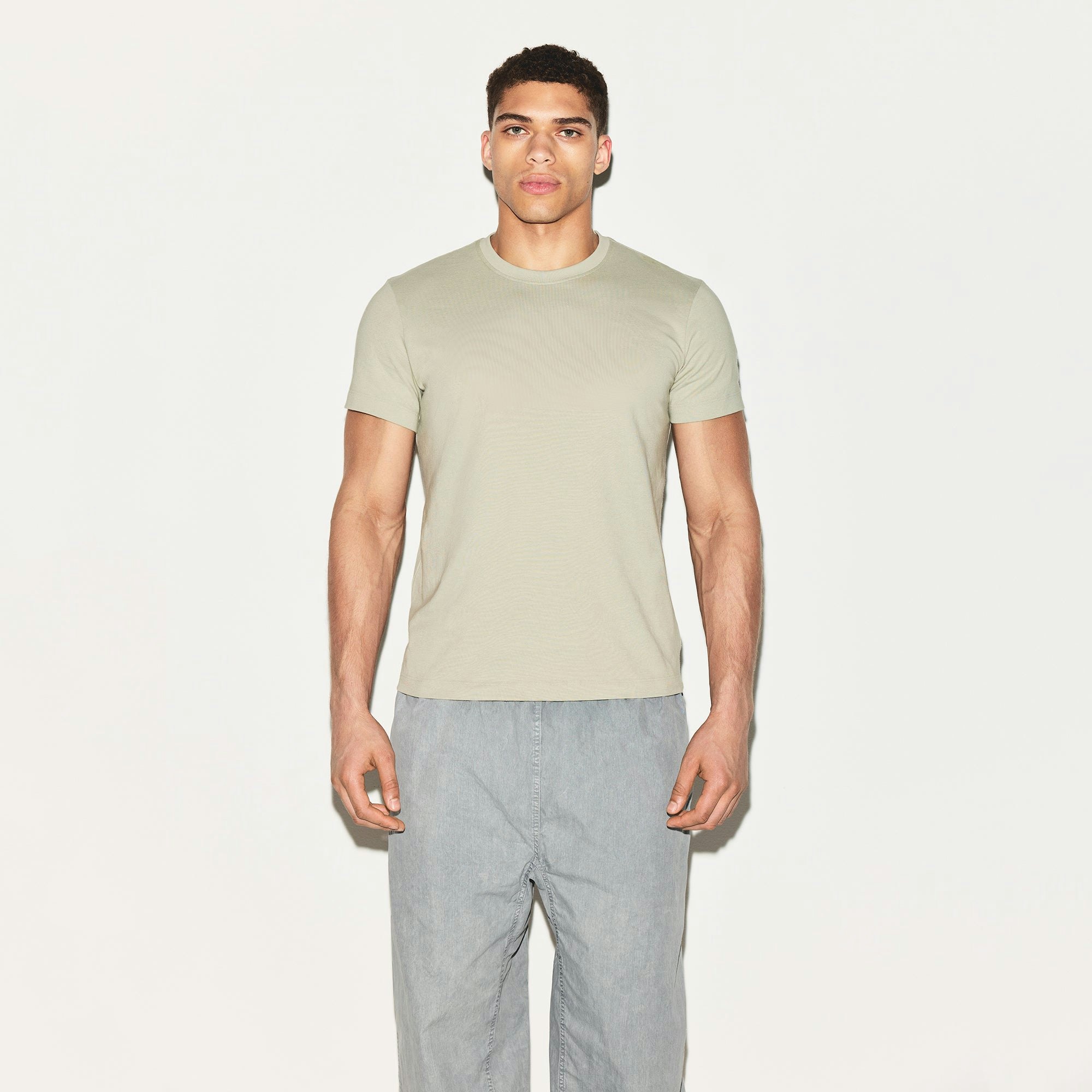 SKIMS COTTON MENS CLASSIC T-SHIRT | TALC ON A MODEL FRONT VIEW | FOCUS: 0.0, 1.0, 0.9