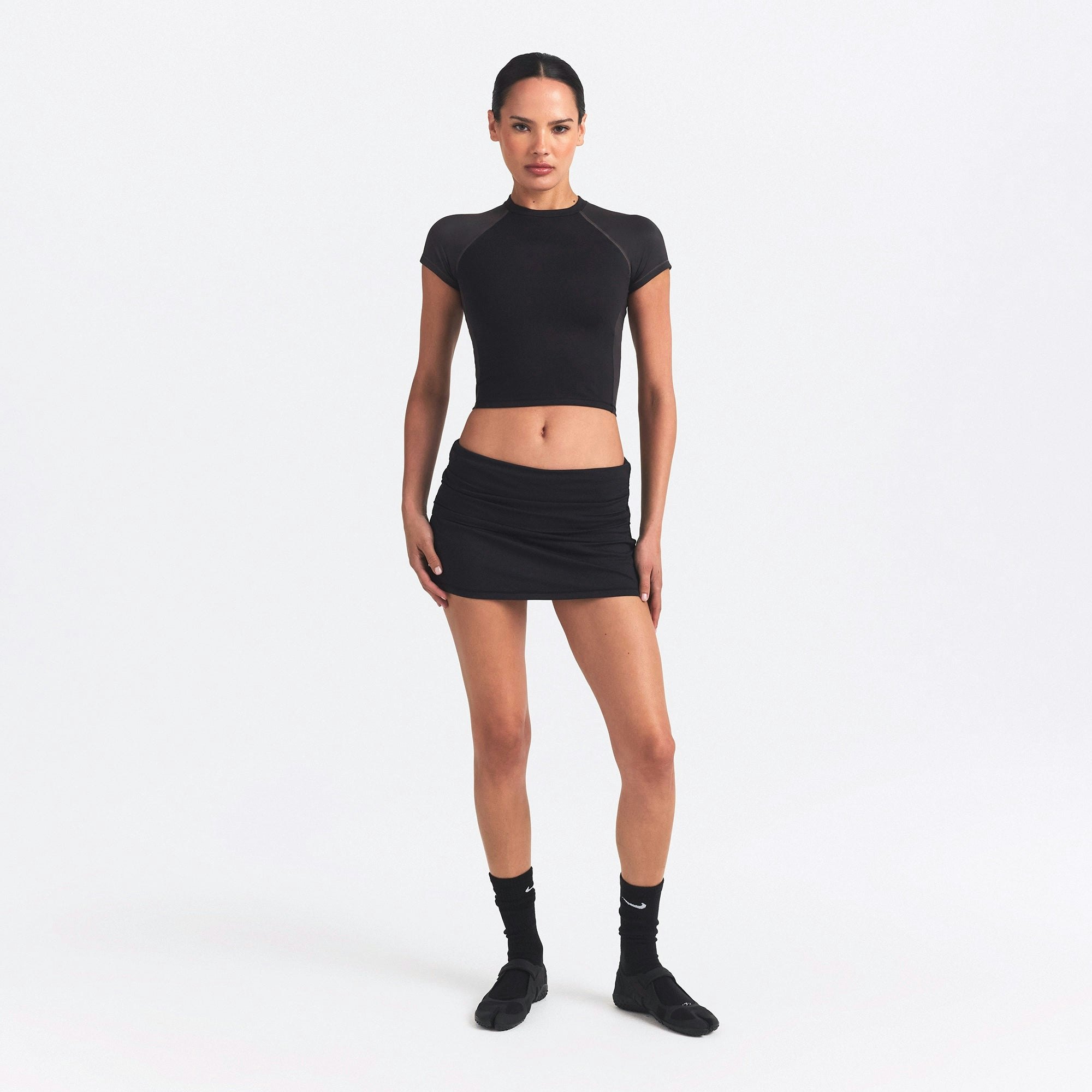 NikeSKIMS MATTE AND SHINE CREWNECK CROP SHORT SLEEVE | OBSIDIAN/IGNEOUS ON A MODEL FRONT VIEW @ | FOCUS: 0.0, 1.0, 0.9
