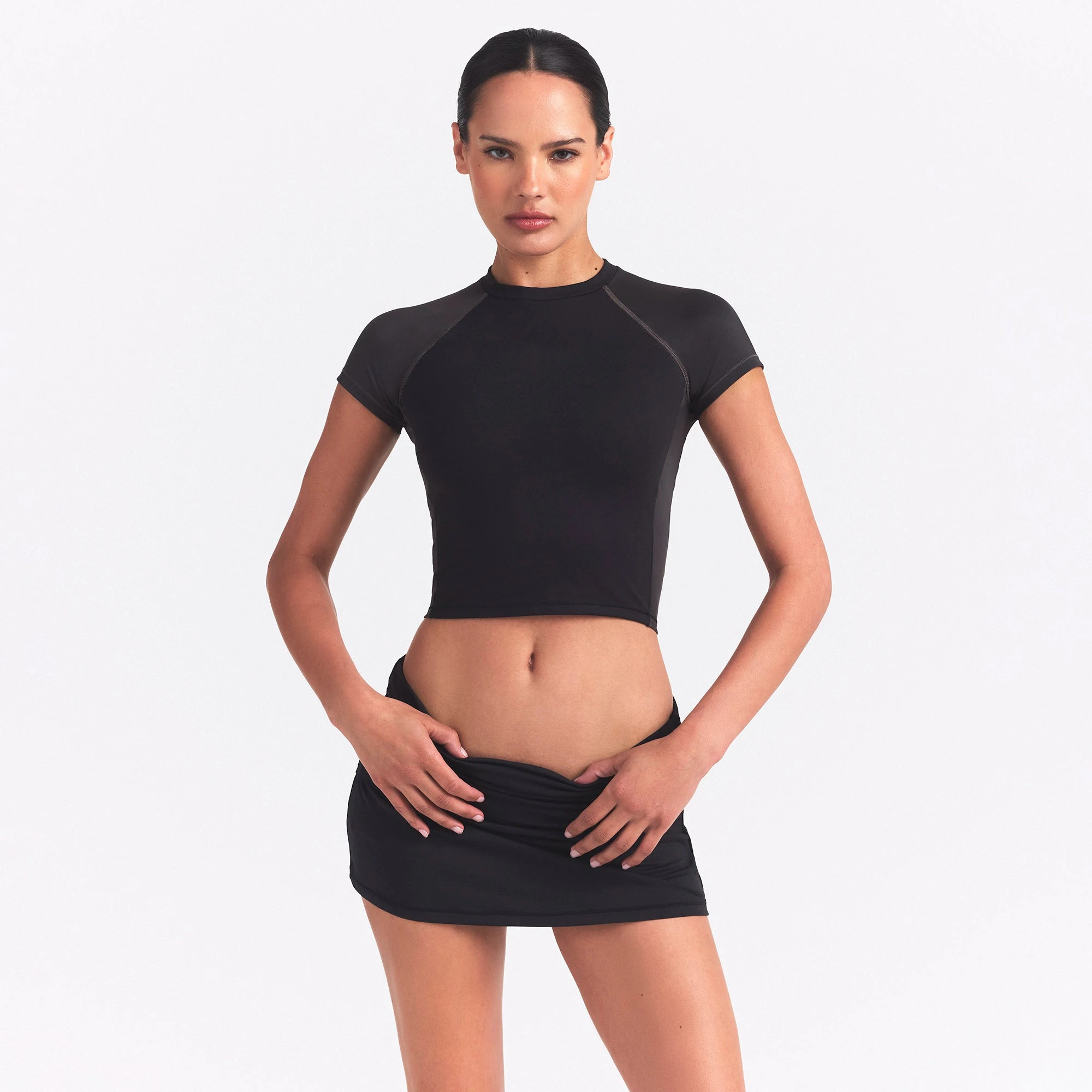 NikeSKIMS MATTE AND SHINE CREWNECK CROP SHORT SLEEVE | OBSIDIAN/IGNEOUS ON A MODEL SIDE VIEW @ | FOCUS: 0.0, 1.0, 0.9