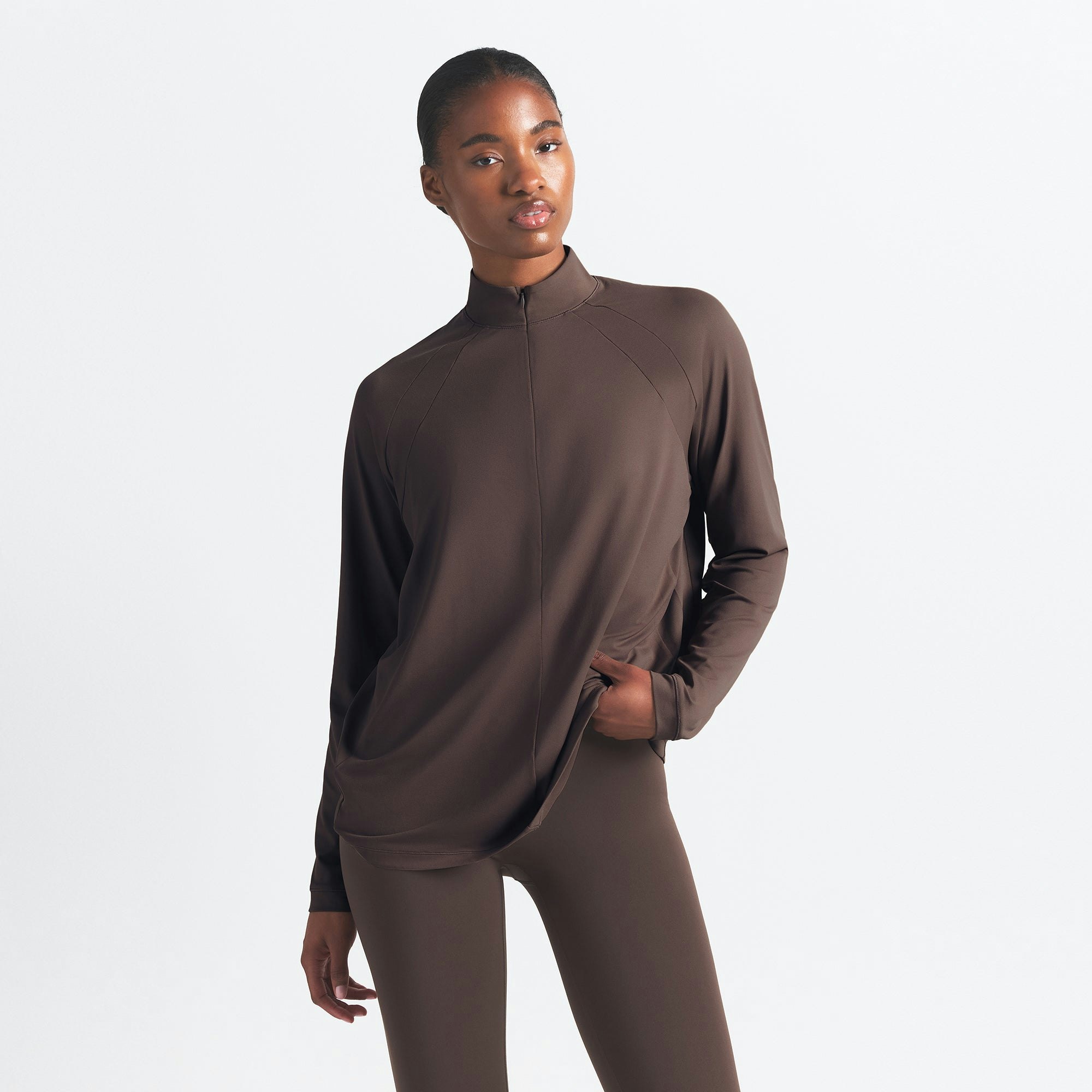 NikeSKIMS AIRY LONG SLEEVE HALF ZIP | DARK SEPIA ON A MODEL SIDE VIEW @ | FOCUS: 0.0, 1.0, 0.9
