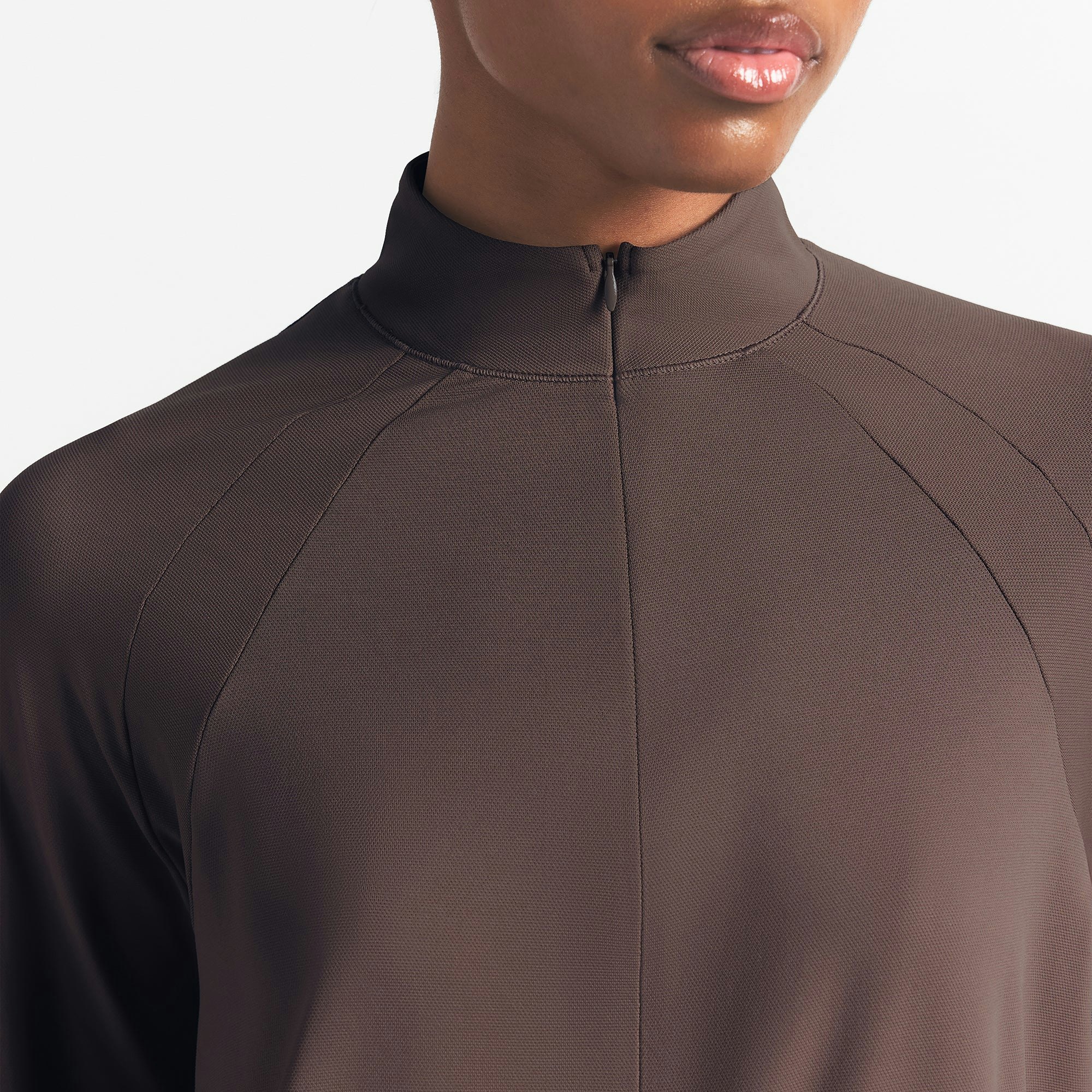 NikeSKIMS AIRY LONG SLEEVE HALF ZIP | DARK SEPIA ON A MODEL SIDE VIEW @ | FOCUS: 0.0, 1.0, 0.9