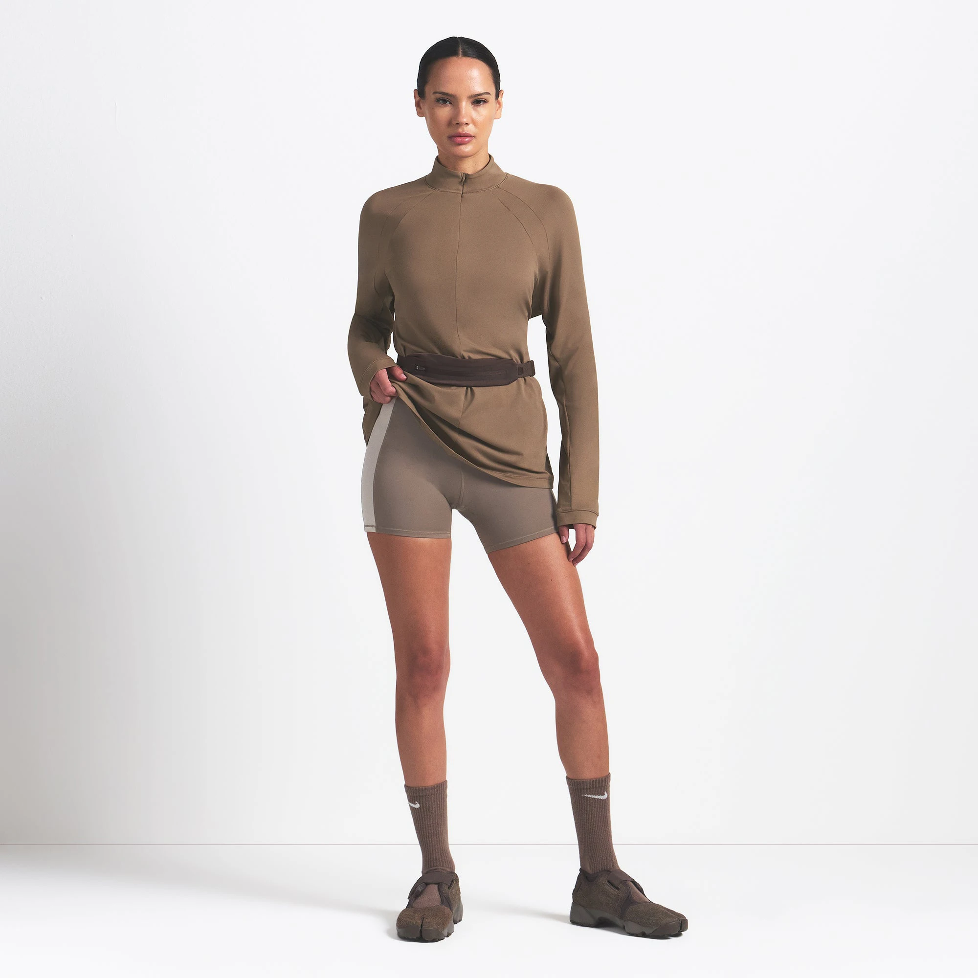 NikeSKIMS AIRY LONG SLEEVE HALF ZIP | MYRRH ON A MODEL FRONT VIEW @ | FOCUS: 0.0, 1.0, 0.9