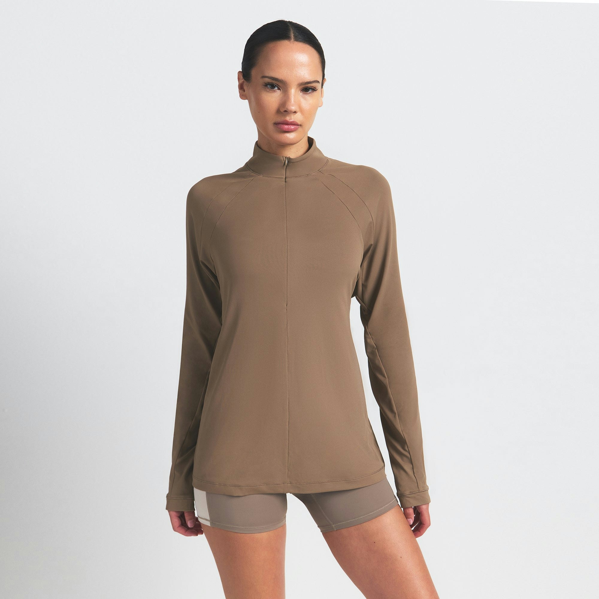 NikeSKIMS AIRY LONG SLEEVE HALF ZIP | MYRRH ON A MODEL SIDE VIEW @ | FOCUS: 0.0, 1.0, 0.9