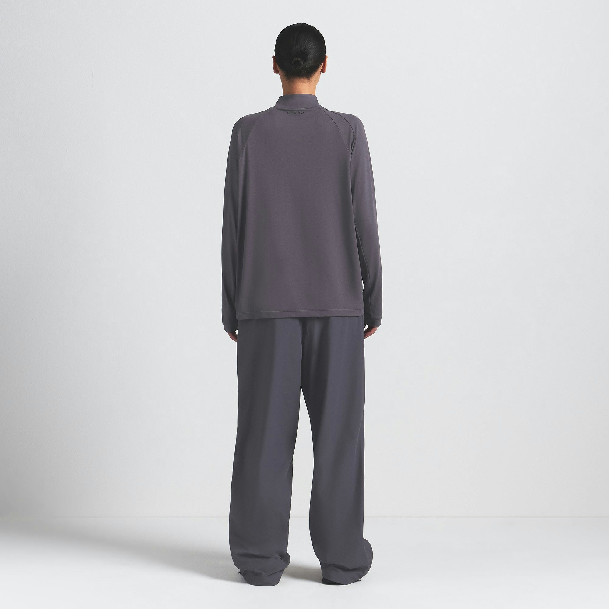 NikeSKIMS AIRY LONG SLEEVE HALF ZIP | RAVEN ON A MODEL FRONT VIEW @ | FOCUS: 0.0, 1.0, 0.9