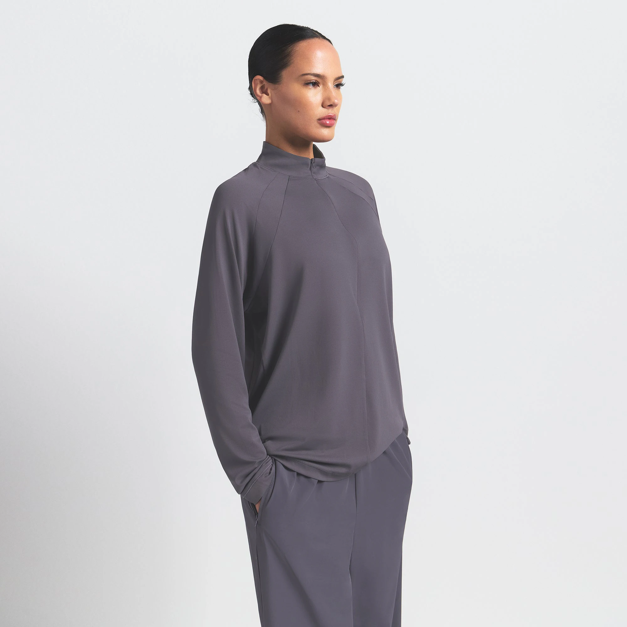 NikeSKIMS AIRY LONG SLEEVE HALF ZIP | RAVEN ON A MODEL SIDE VIEW @ | FOCUS: 0.0, 1.0, 0.9