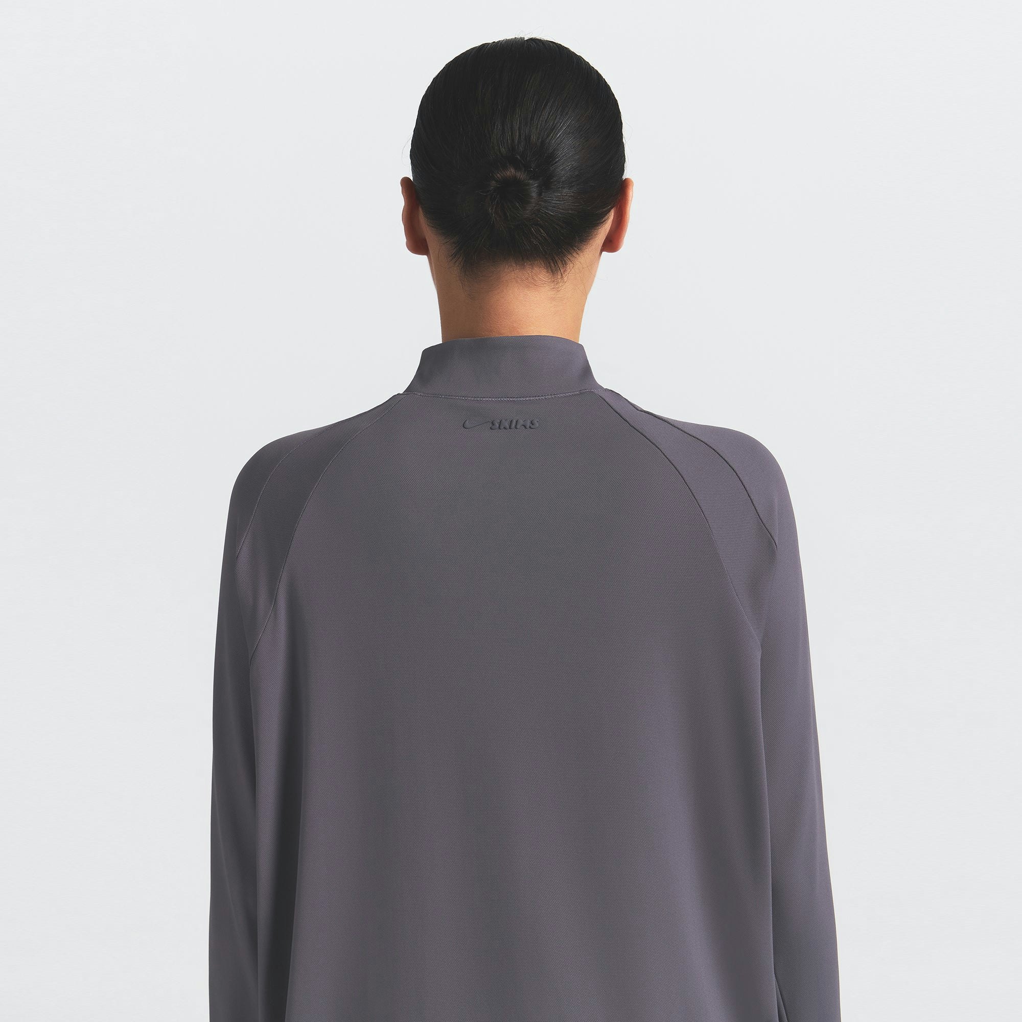 NikeSKIMS AIRY LONG SLEEVE HALF ZIP | RAVEN ON A MODEL SIDE VIEW @ | FOCUS: 0.0, 1.0, 0.9
