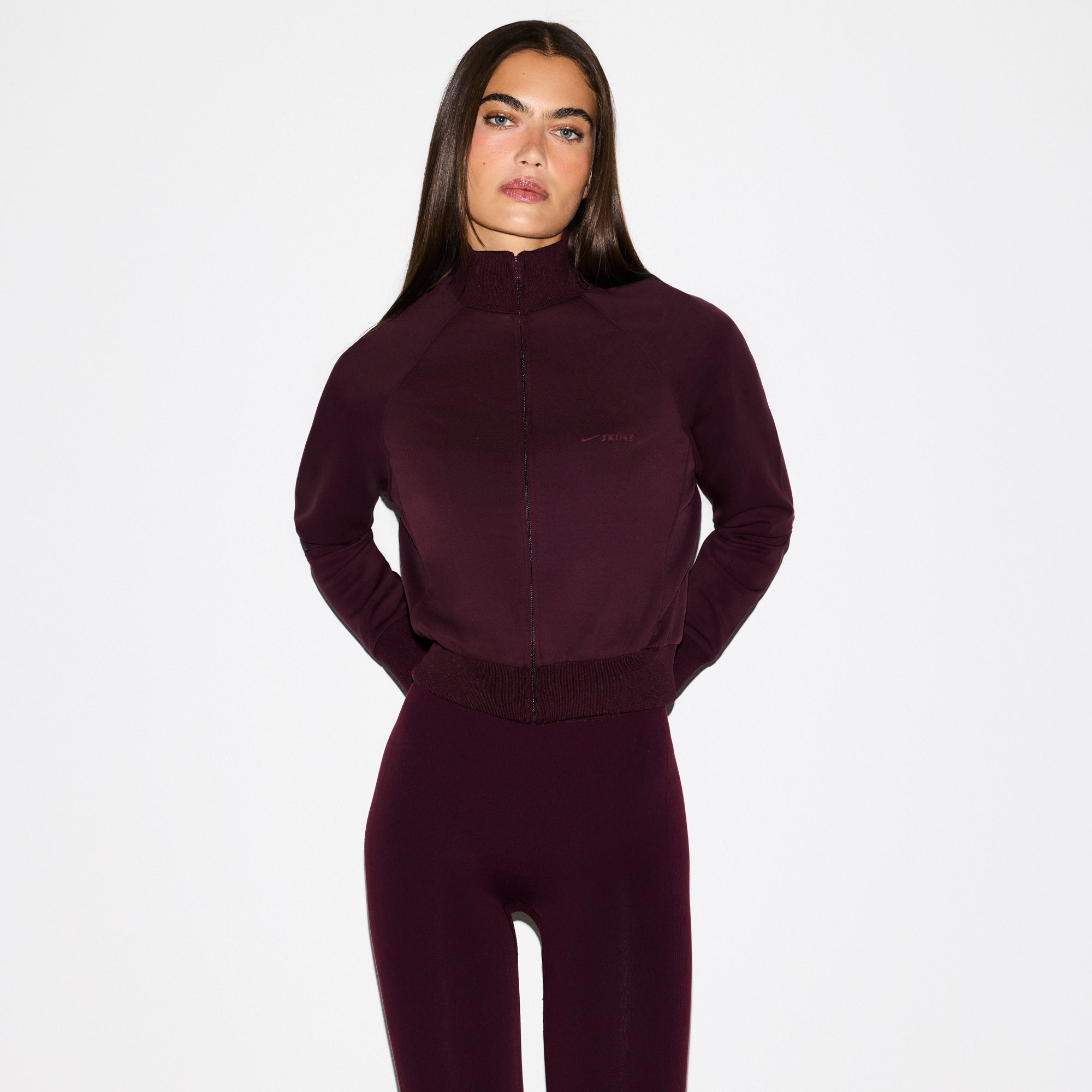 NikeSKIMS MATTE TRICOT TRACK JACKET | CURRANT ON A MODEL SIDE VIEW @ | FOCUS: 0.0, 1.0, 0.9