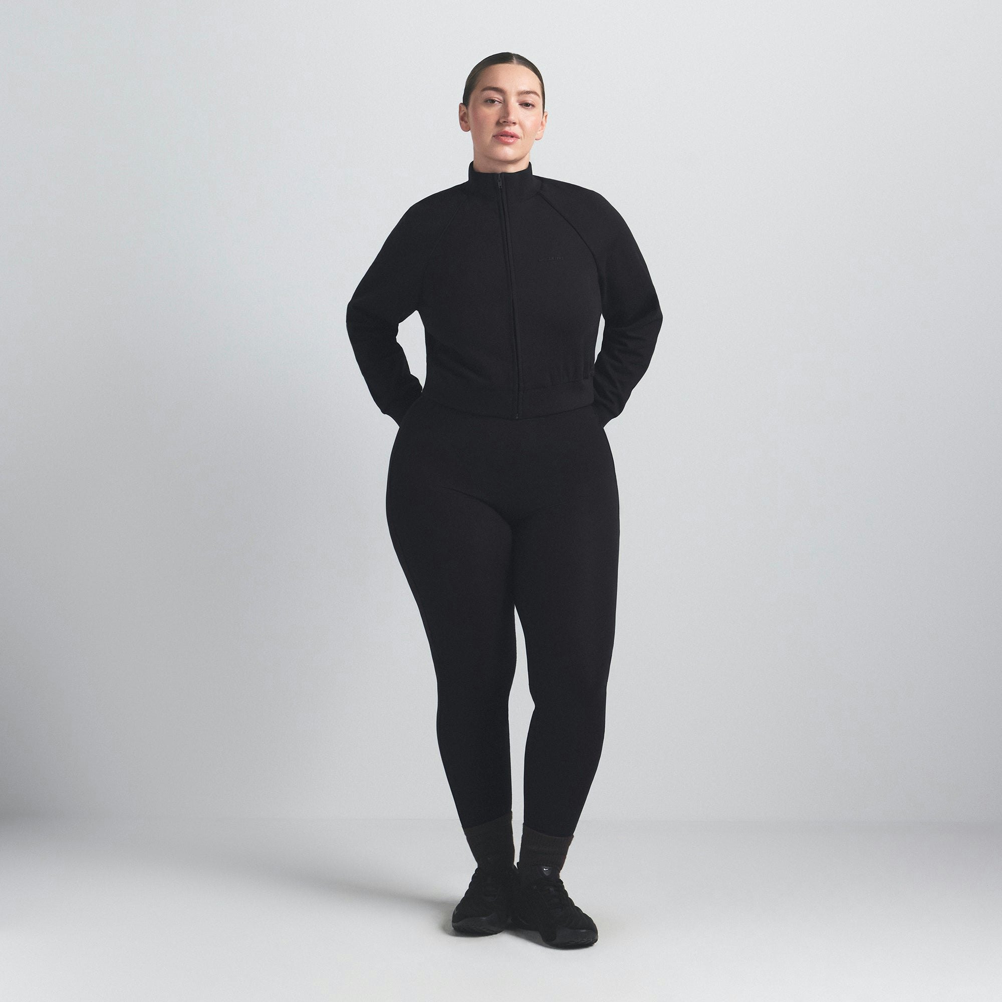 NikeSKIMS MATTE TRICOT TRACK JACKET | OBSIDIAN ON A MODEL FRONT VIEW @ | FOCUS: 0.9, 0.1, 0.7