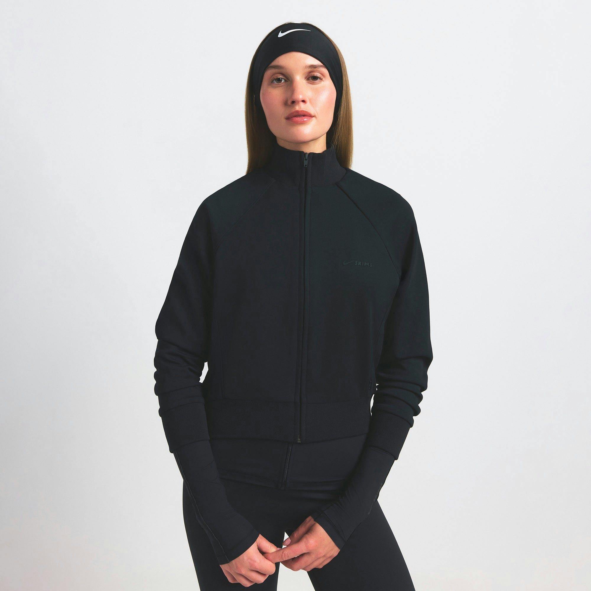 NikeSKIMS MATTE TRICOT TRACK JACKET | OBSIDIAN ON A MODEL SIDE VIEW @ | FOCUS: 0.9, 0.1, 0.7