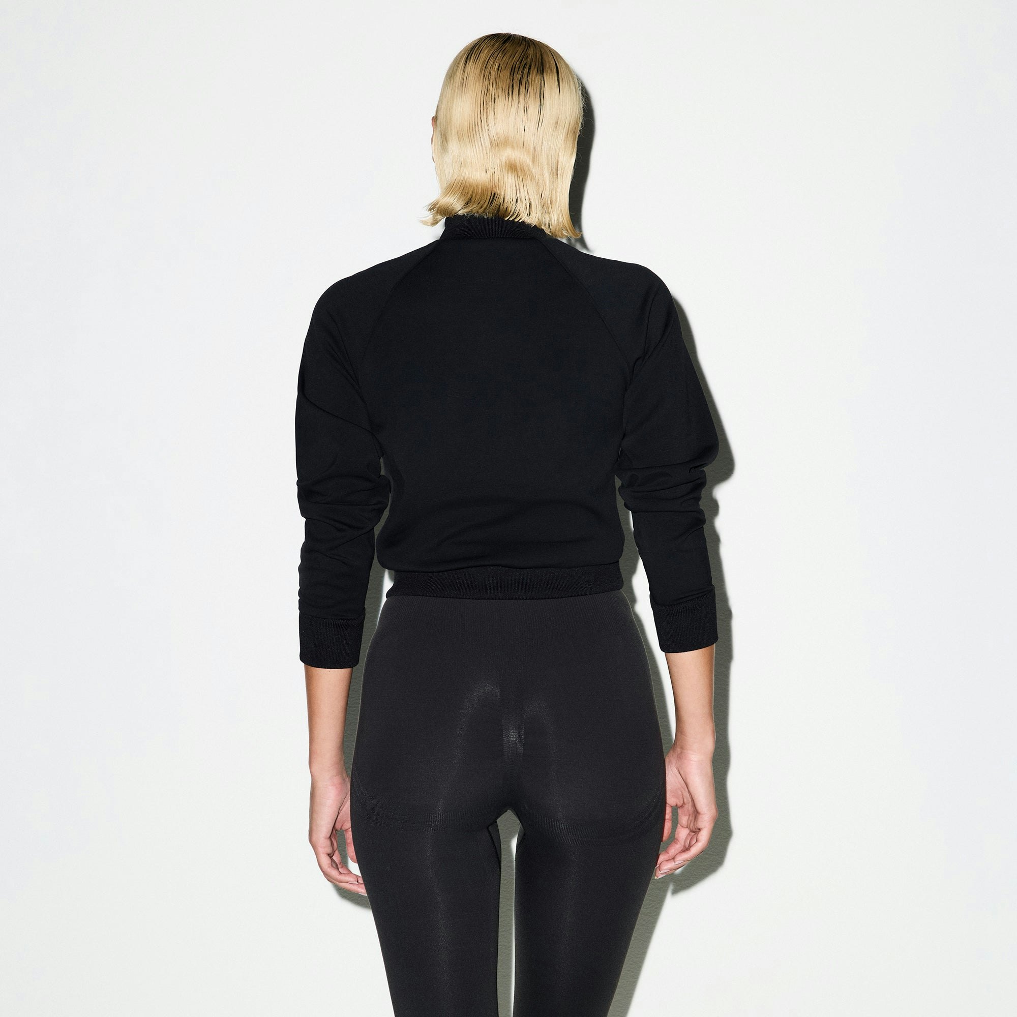 NikeSKIMS MATTE TRICOT TRACK JACKET | OBSIDIAN ON A MODEL SIDE VIEW @ | FOCUS: 0.0, 1.0, 0.9