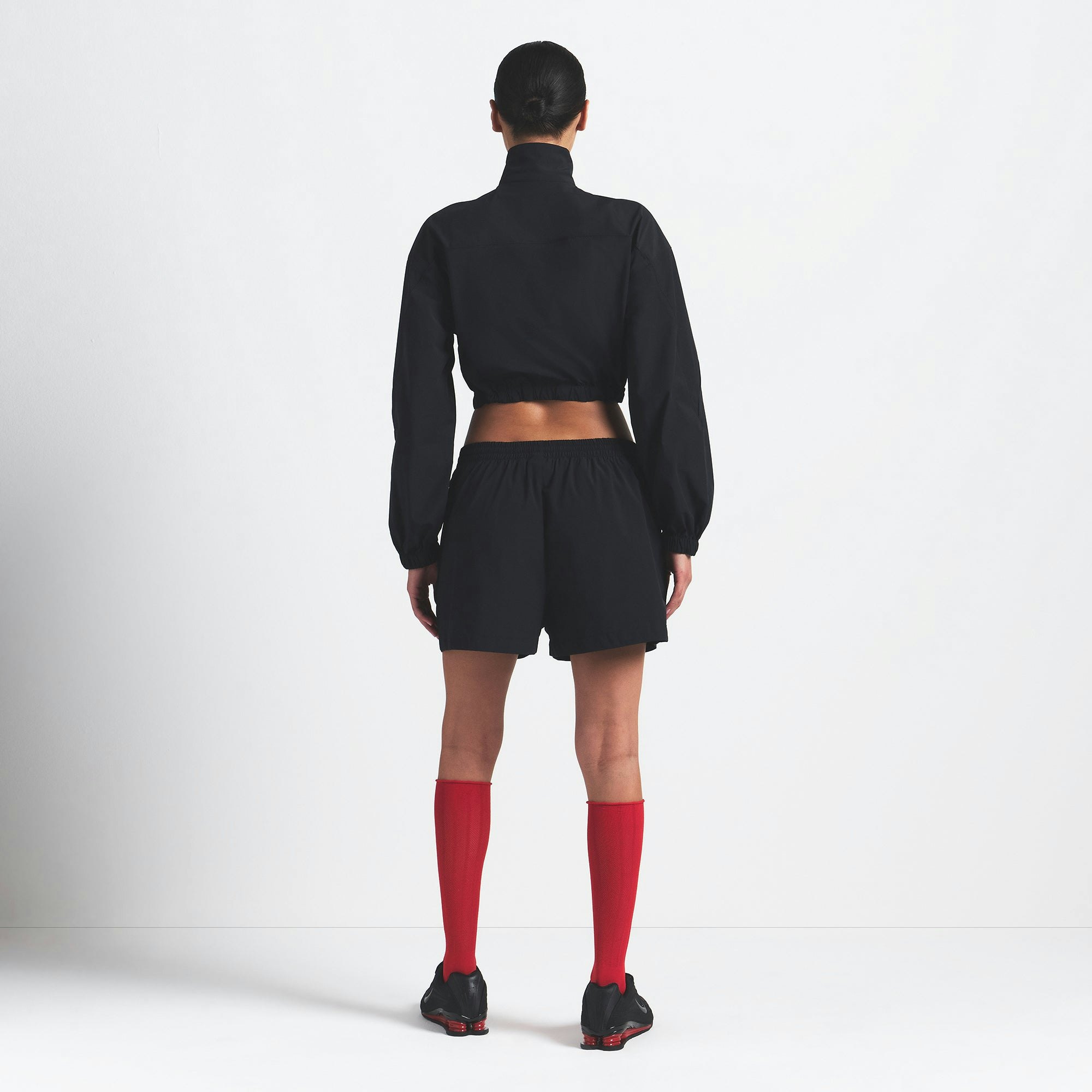 NikeSKIMS WOVEN NYLON CROP JACKET | OBSIDIAN ON A MODEL BACK VIEW @ | FOCUS: 0.0, 1.0, 0.9