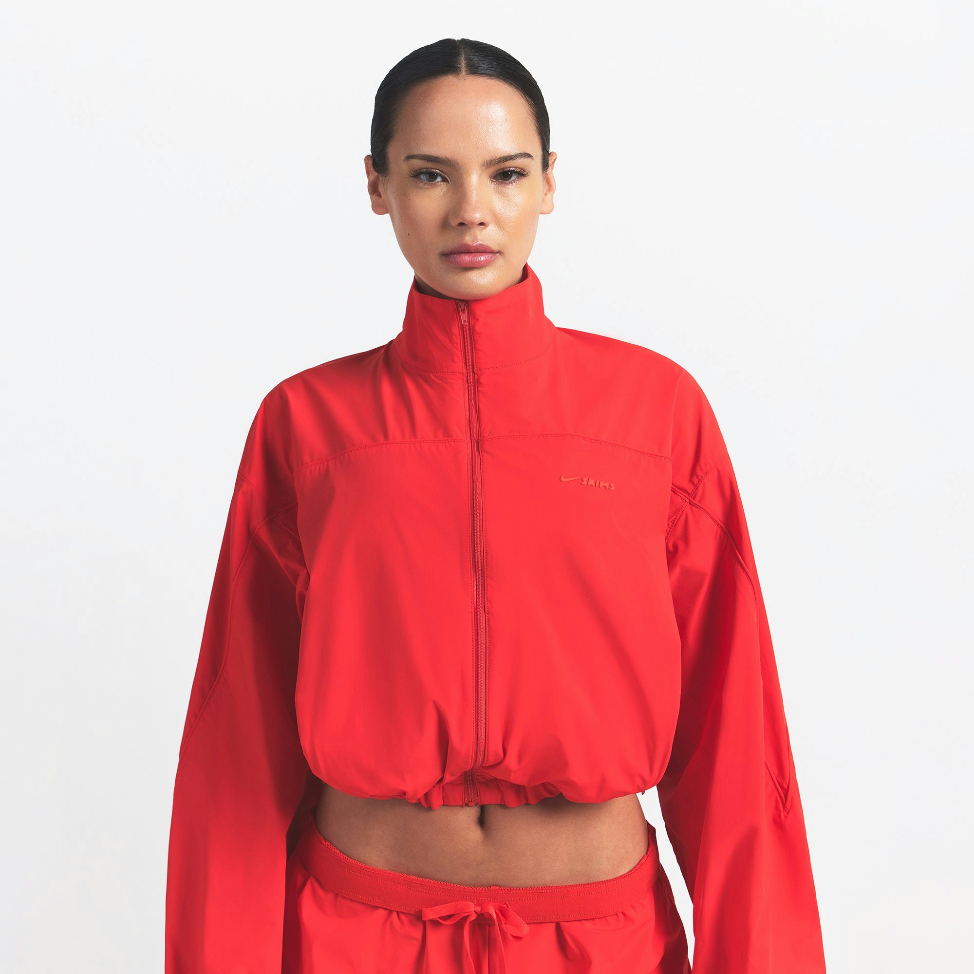 NikeSKIMS WOVEN NYLON CROP JACKET | RUBY ON A MODEL FRONT VIEW @ | FOCUS: 0.0, 1.0, 0.9
