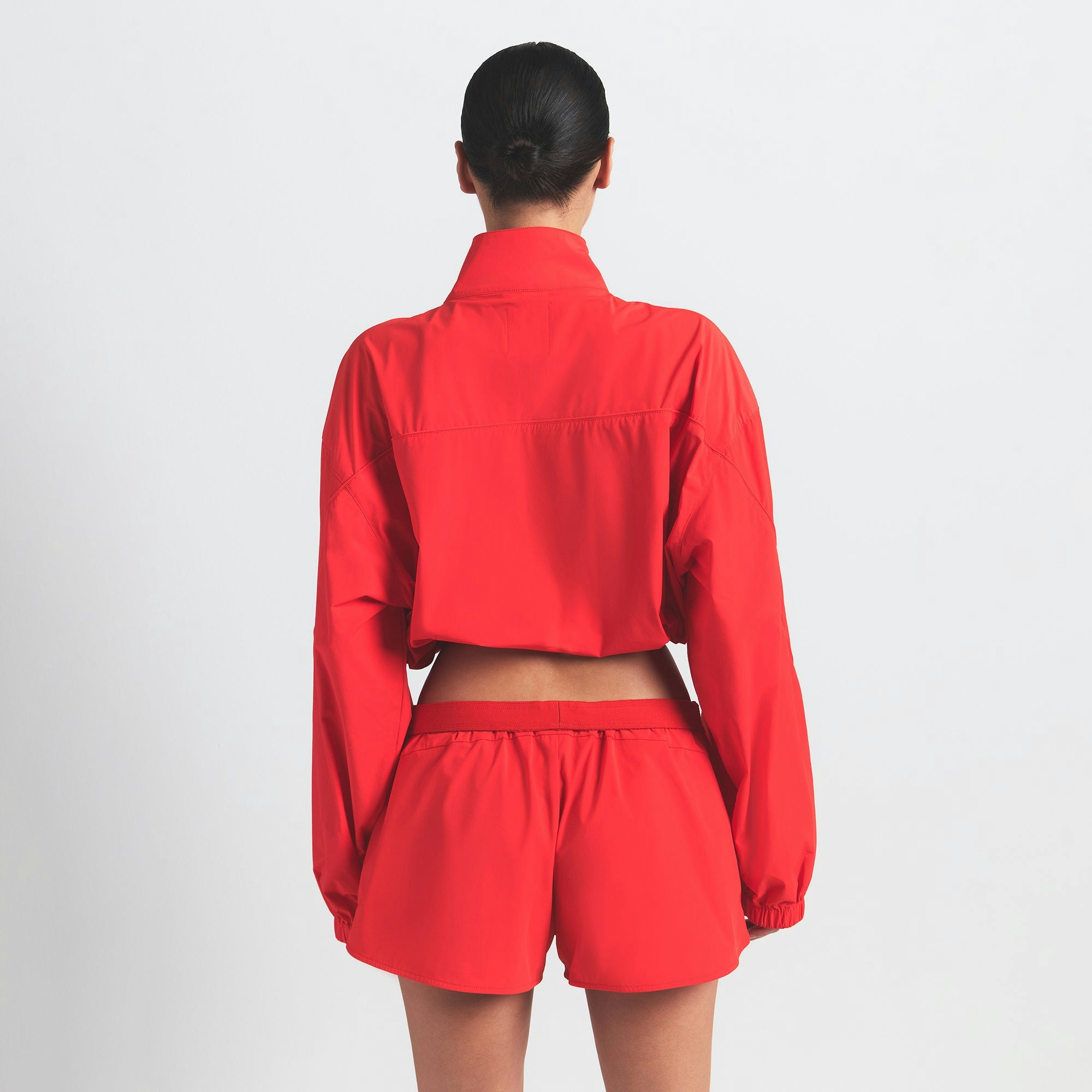 NikeSKIMS WOVEN NYLON CROP JACKET | RUBY ON A MODEL BACK VIEW @ | FOCUS: 0.0, 1.0, 0.9