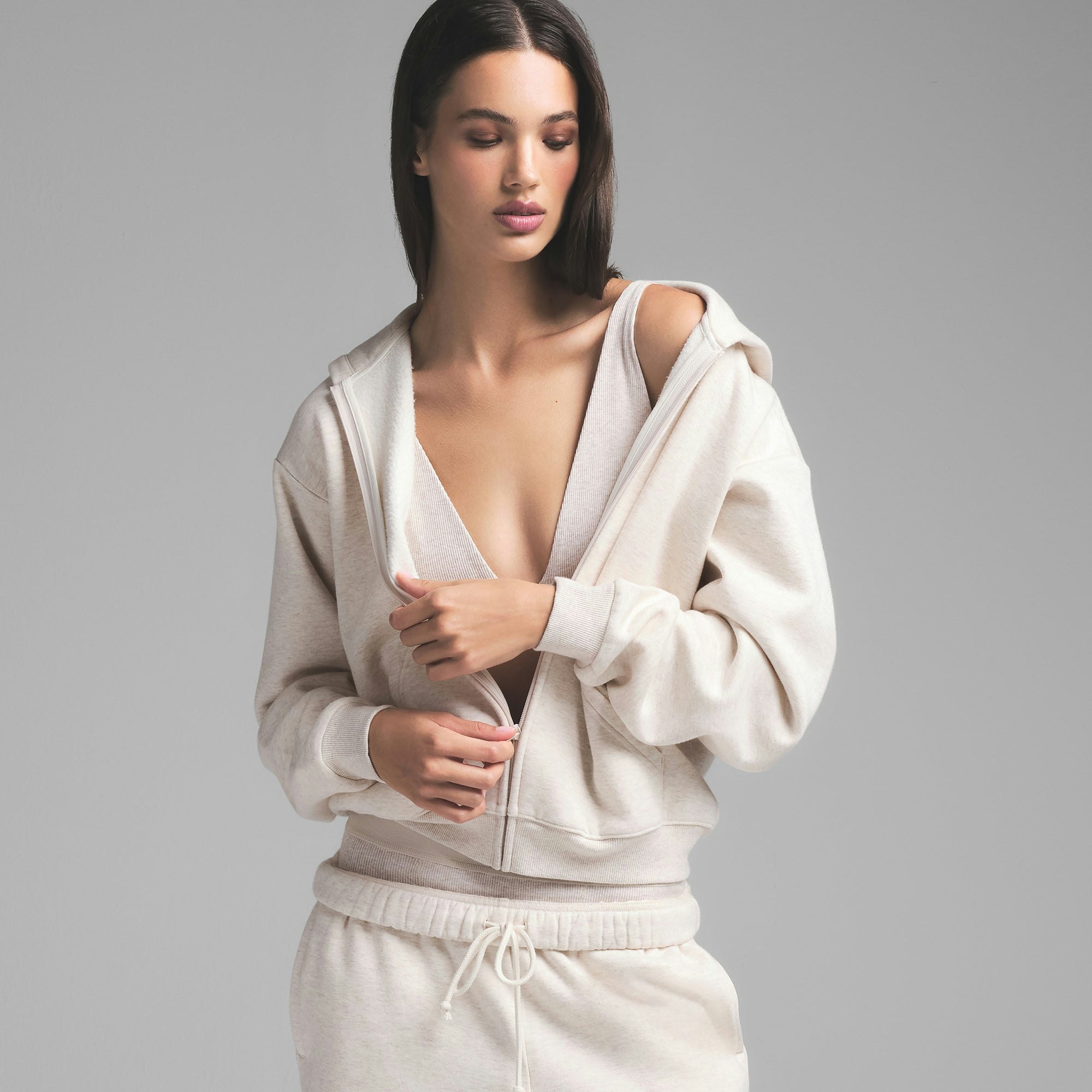 COTTON FLEECE CLASSIC ZIP UP HOODIE | HEATHER OATMEAL ON A MODEL SIDE VIEW