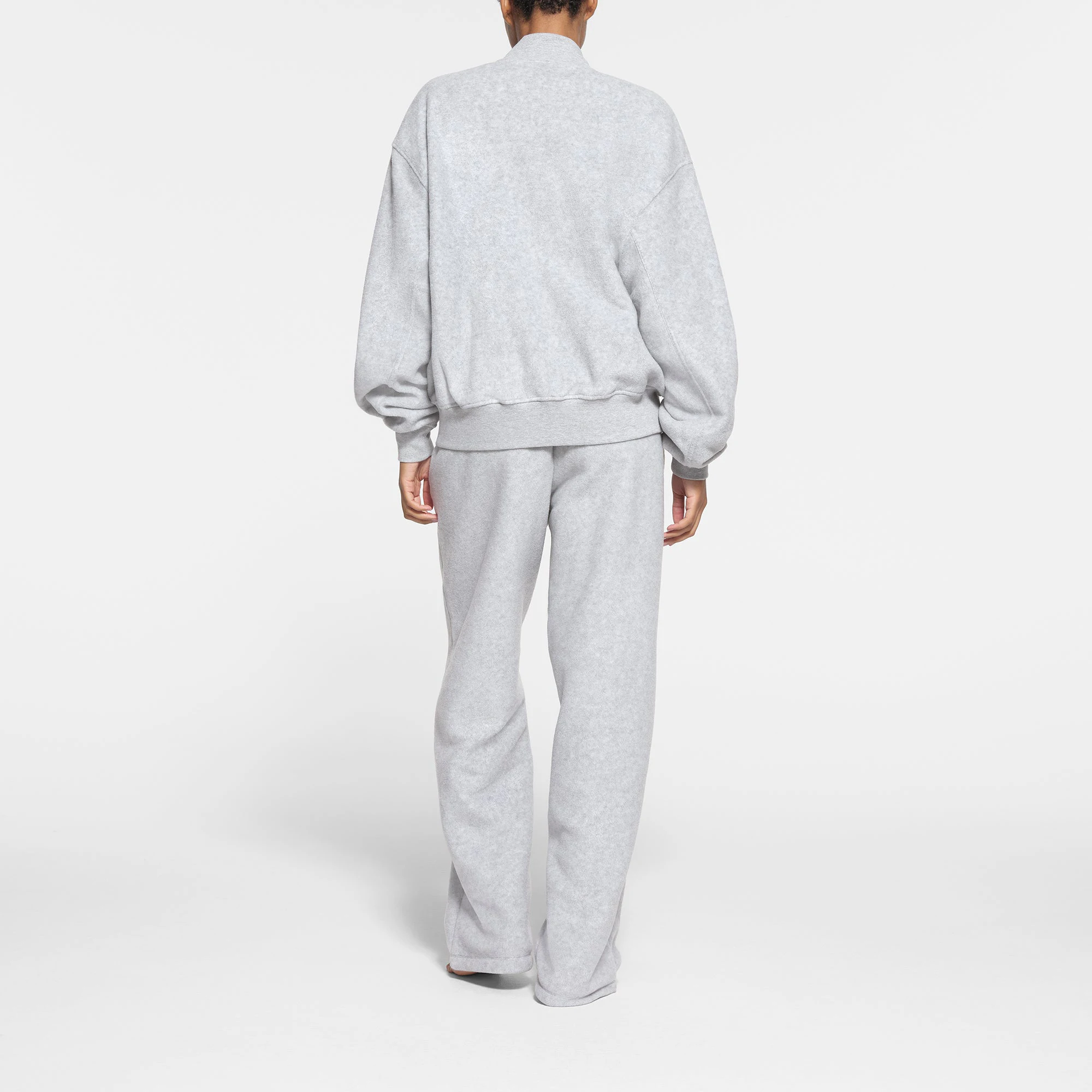 FLEECE LOUNGE BOMBER JACKET | LIGHT HEATHER GREY ON A MODEL BACK VIEW