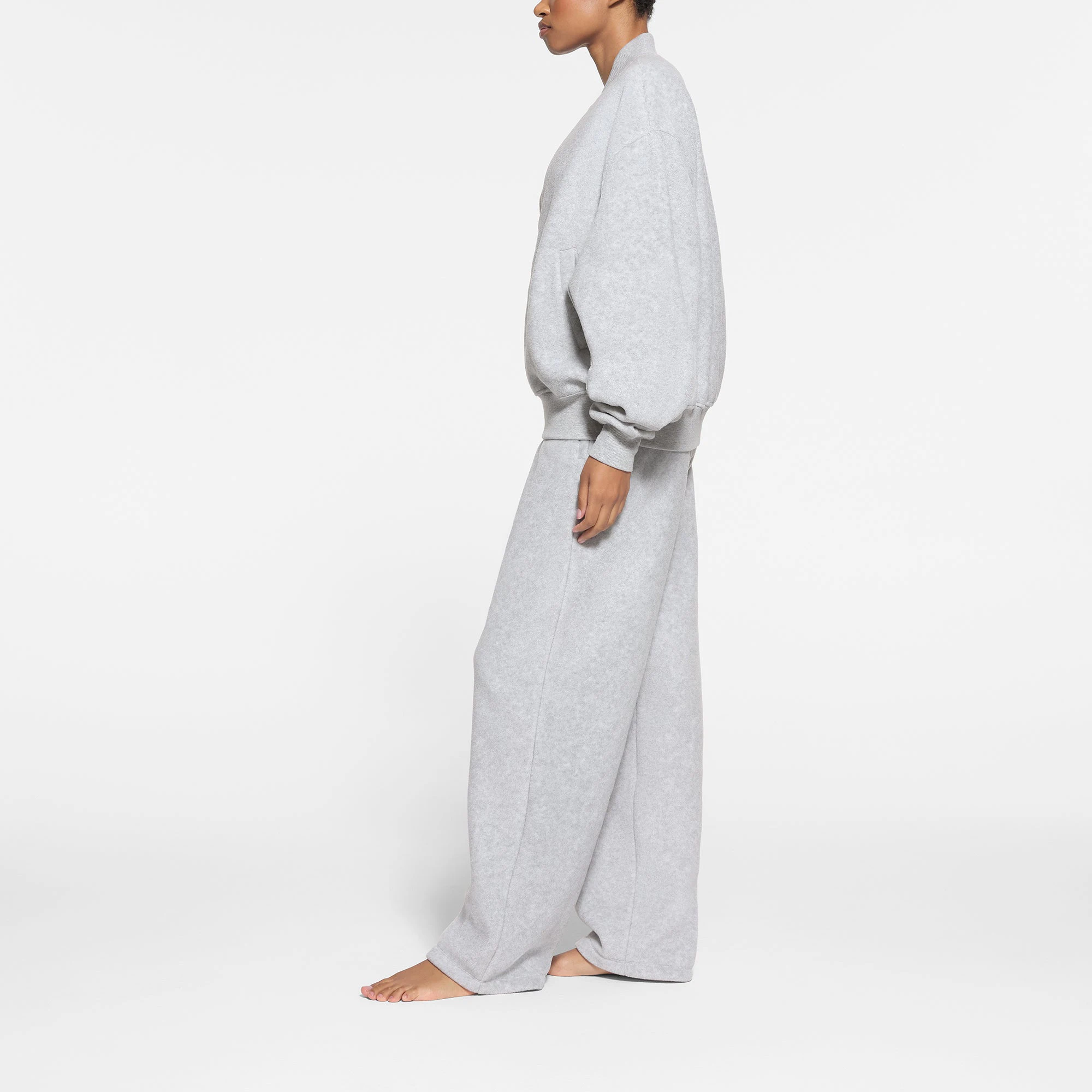 FLEECE LOUNGE BOMBER JACKET | LIGHT HEATHER GREY ON A MODEL SIDE VIEW