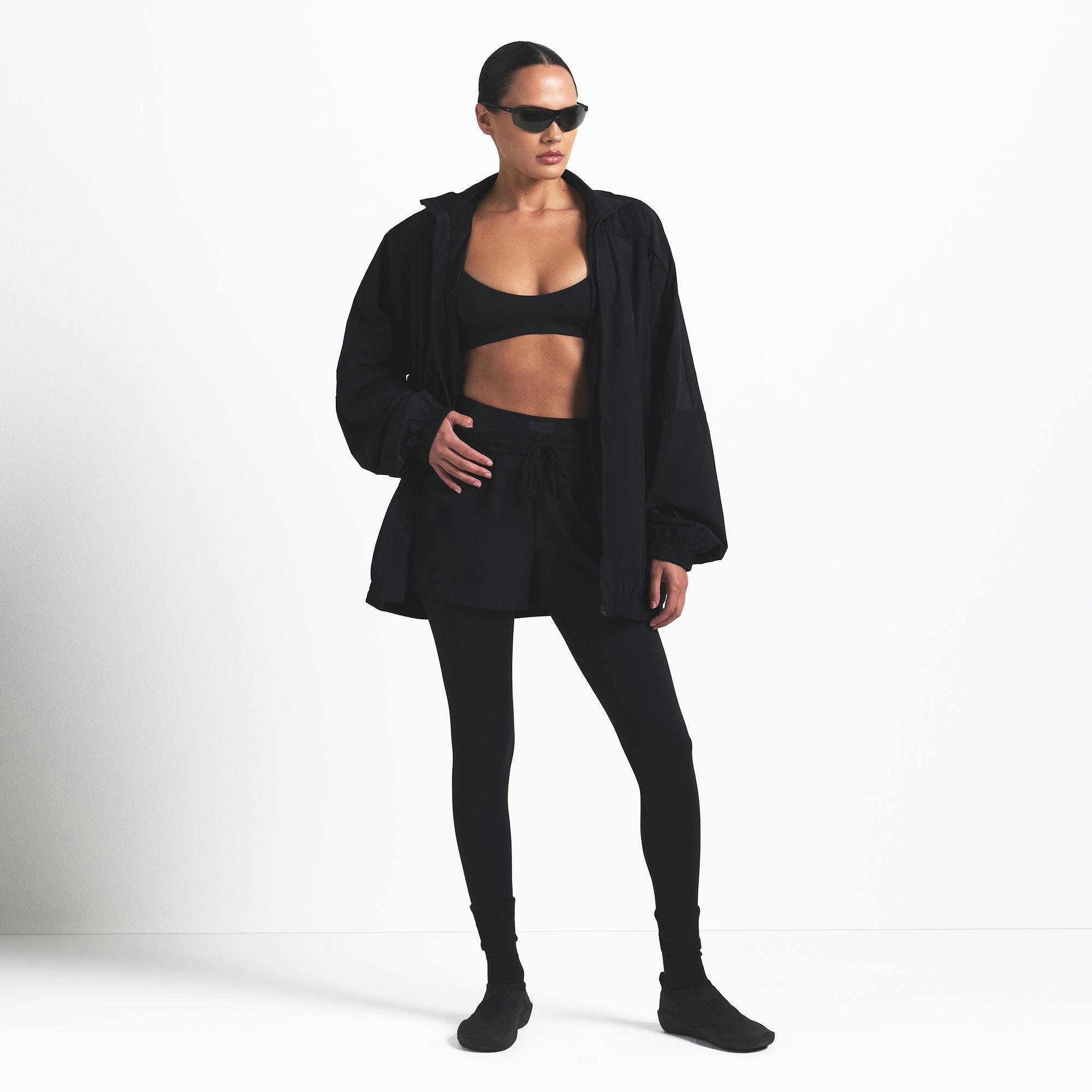 NikeSKIMS WOVEN NYLON OVERSIZED TRACK JACKET | OBSIDIAN ON A MODEL FRONT VIEW @ | FOCUS: 0.0, 1.0, 0.9