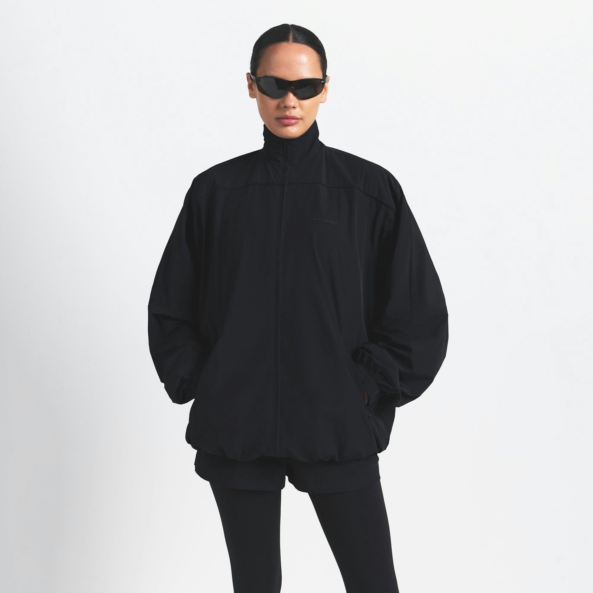 NikeSKIMS WOVEN NYLON OVERSIZED TRACK JACKET | OBSIDIAN ON A MODEL FRONT VIEW @ | FOCUS: 0.0, 1.0, 0.9