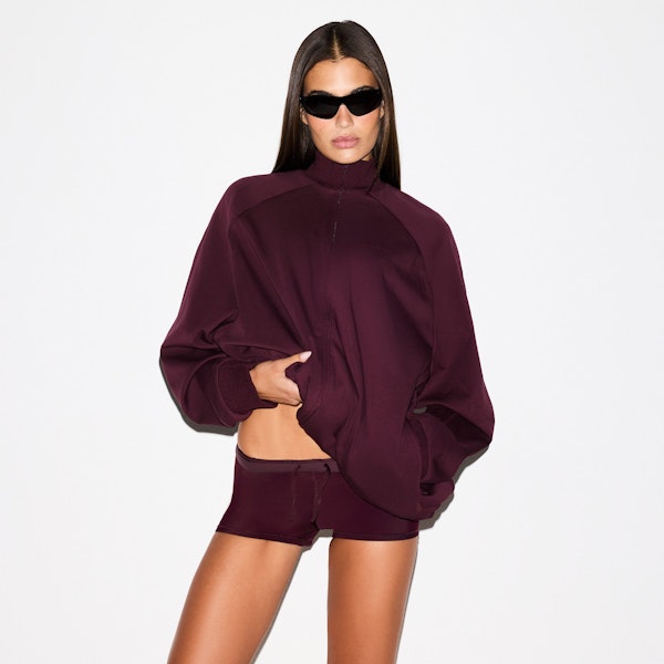 NikeSKIMS MATTE TRICOT OVERSIZED TRACK JACKET | CURRANT ON A MODEL SIDE VIEW