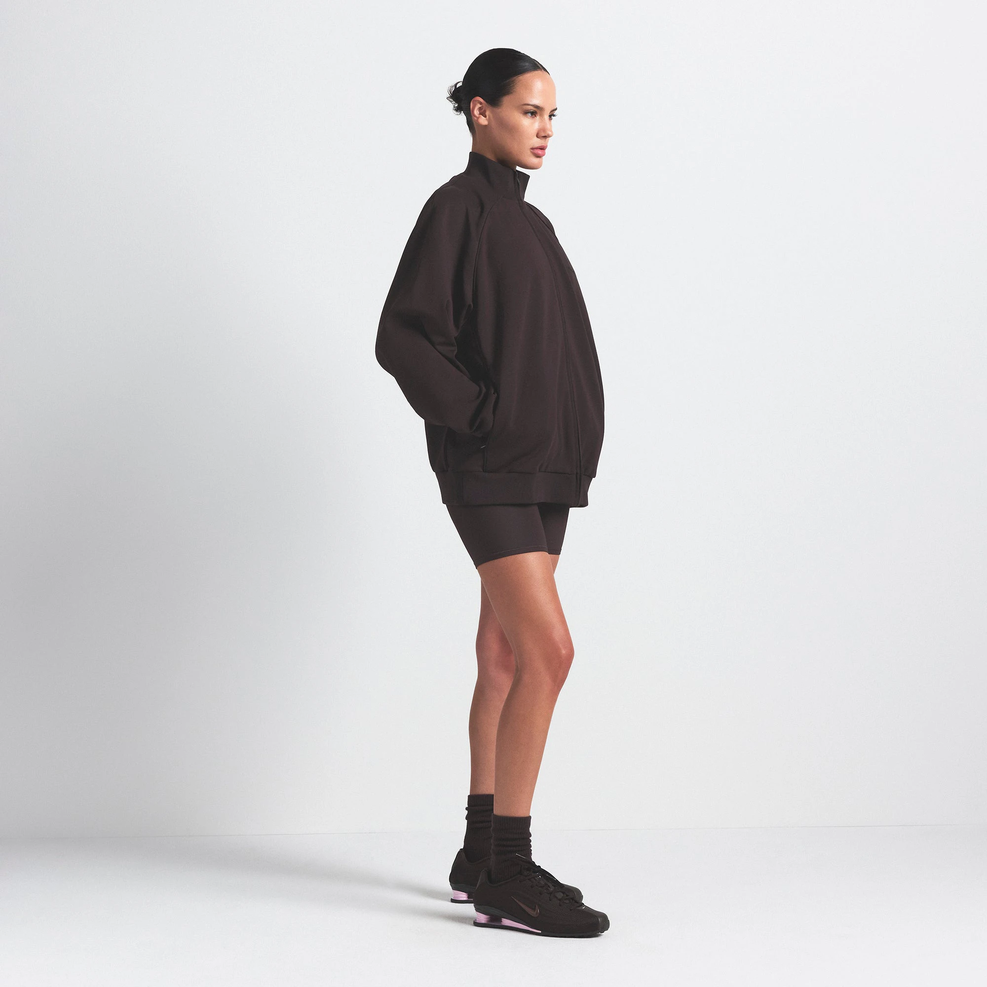 NikeSKIMS MATTE TRICOT OVERSIZED TRACK JACKET | DARK ROAST ON A MODEL SIDE VIEW @ | FOCUS: 0.0, 1.0, 0.9