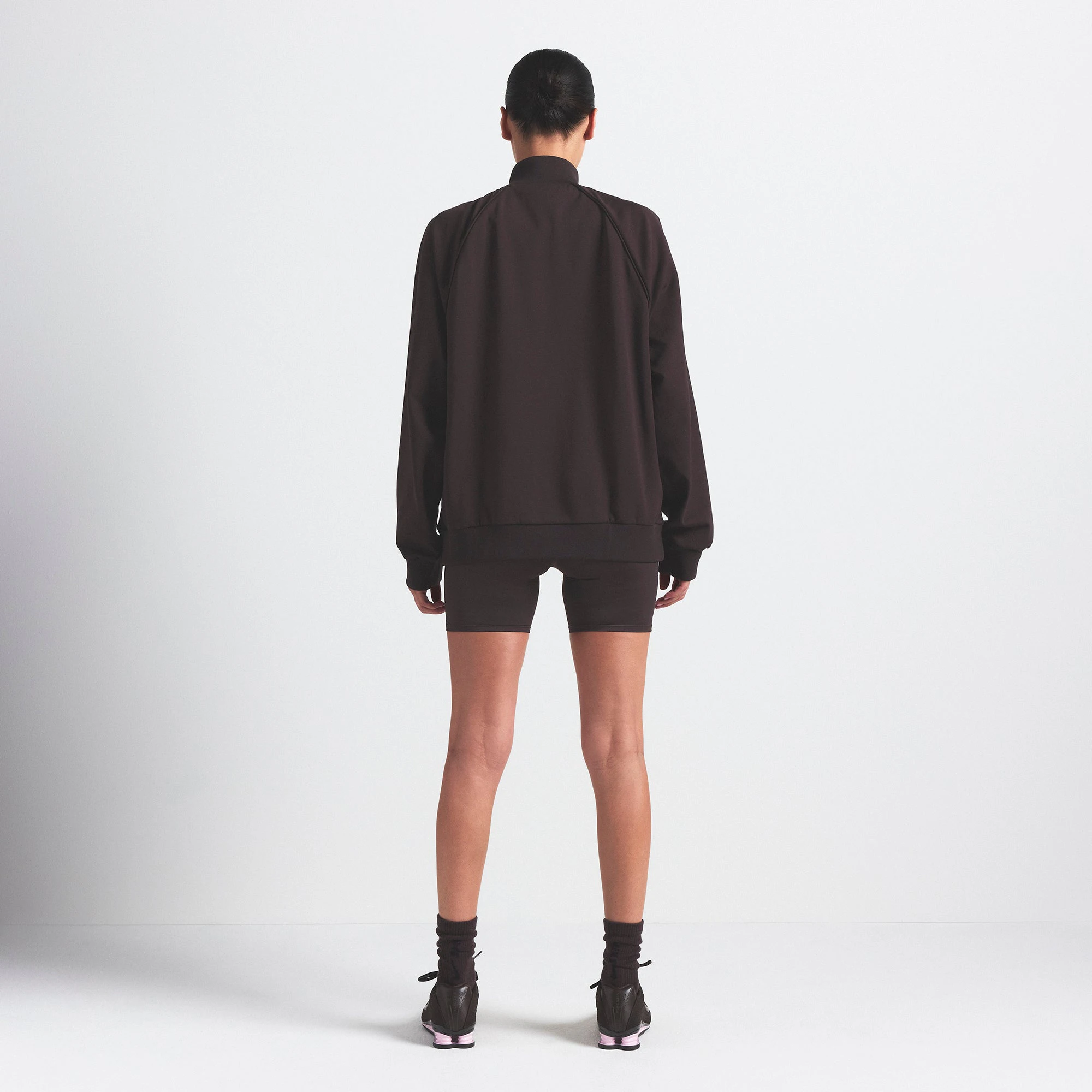 NikeSKIMS MATTE TRICOT OVERSIZED TRACK JACKET | DARK ROAST ON A MODEL SIDE VIEW @ | FOCUS: 0.0, 1.0, 0.9