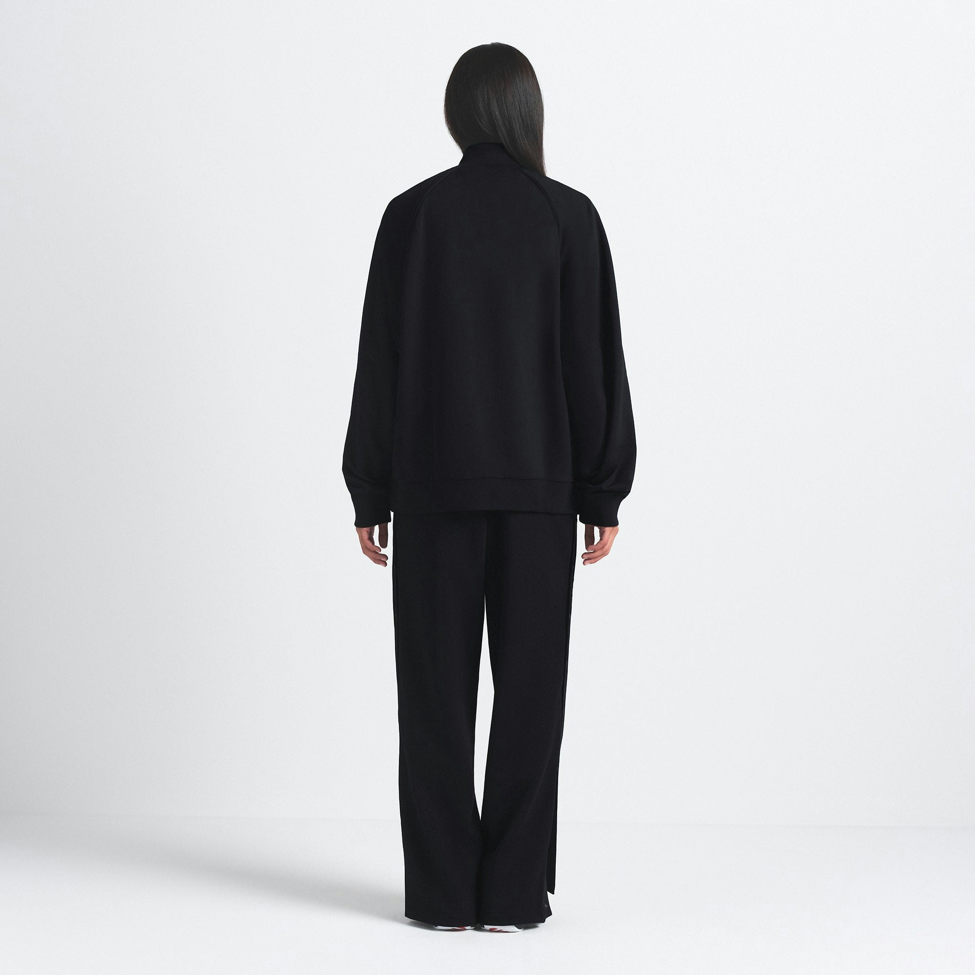 NikeSKIMS MATTE TRICOT OVERSIZED TRACK JACKET | OBSIDIAN ON A MODEL SIDE VIEW @ | FOCUS: 0.9, 0.1, 0.7