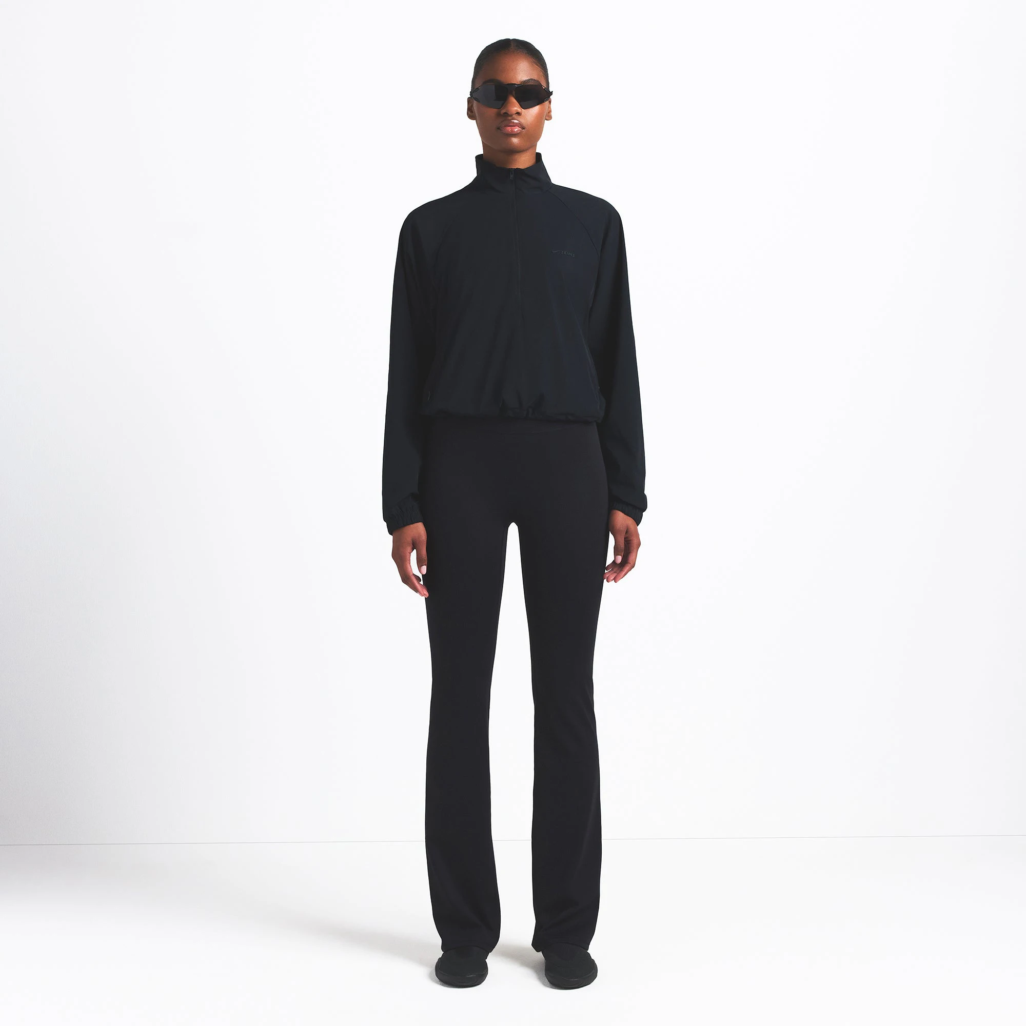 NikeSKIMS WOVEN NYLON HALF ZIP JACKET | OBSIDIAN ON A MODEL FRONT VIEW @ | FOCUS: 0.0, 1.0, 0.9